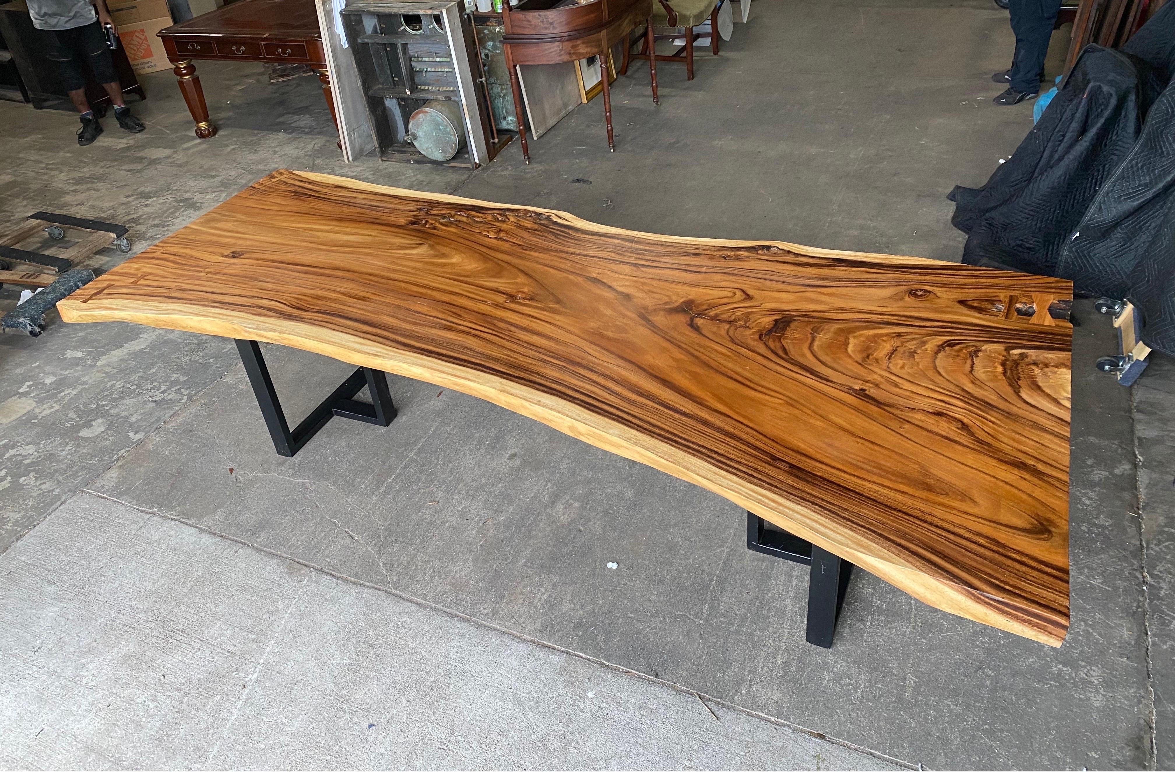 Large and impressive nearly 10' live edge walnut table or desk mounted on iron bases.