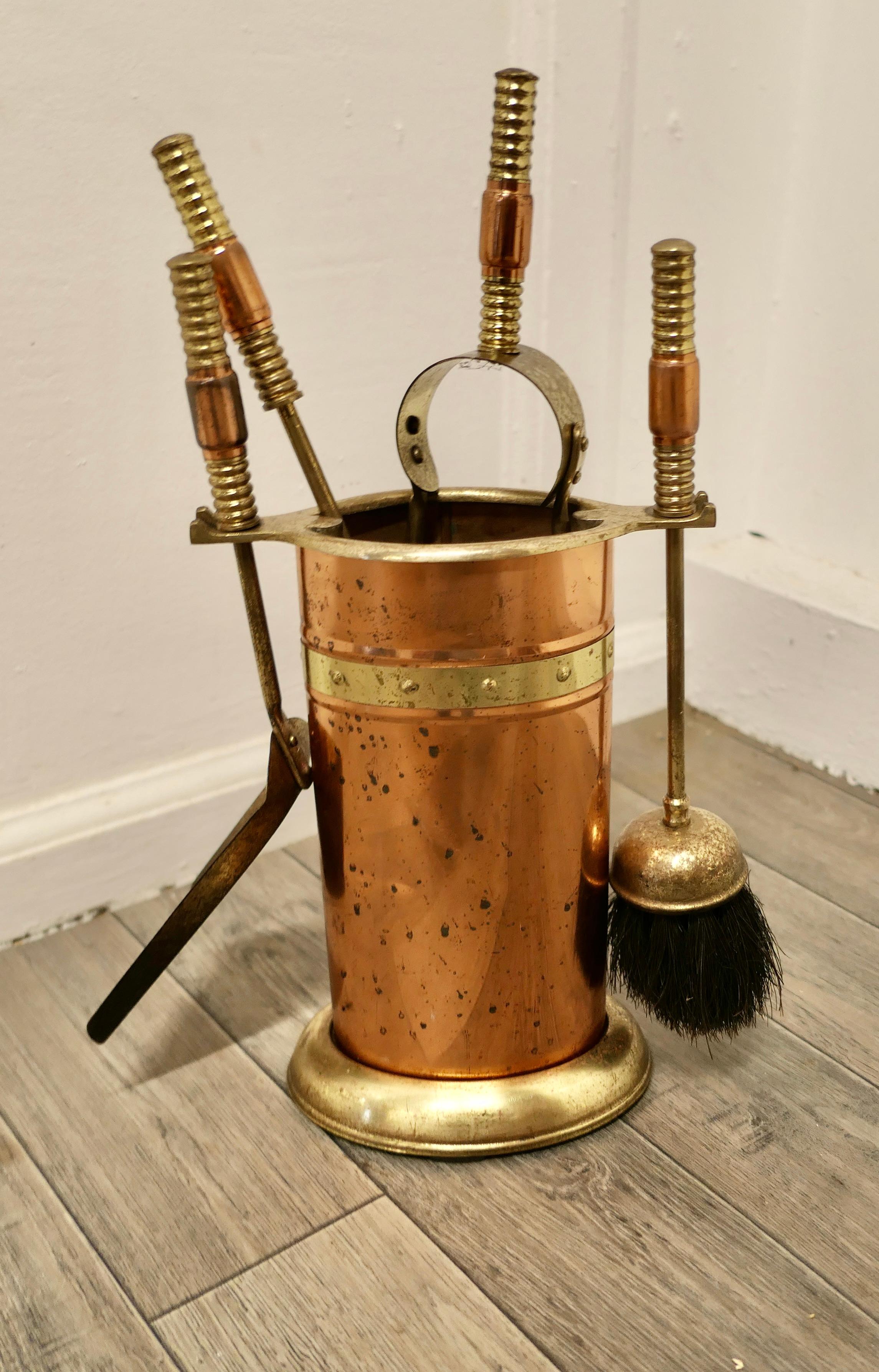Neat copper and brass fireside companion set, fireside tools.

This is a heavy little set in its own stand, shovel, tongs, poker and hearth brush

Compact and in good used condition, it stands 16” tall, 7” wide and 5” deep
TJK192.