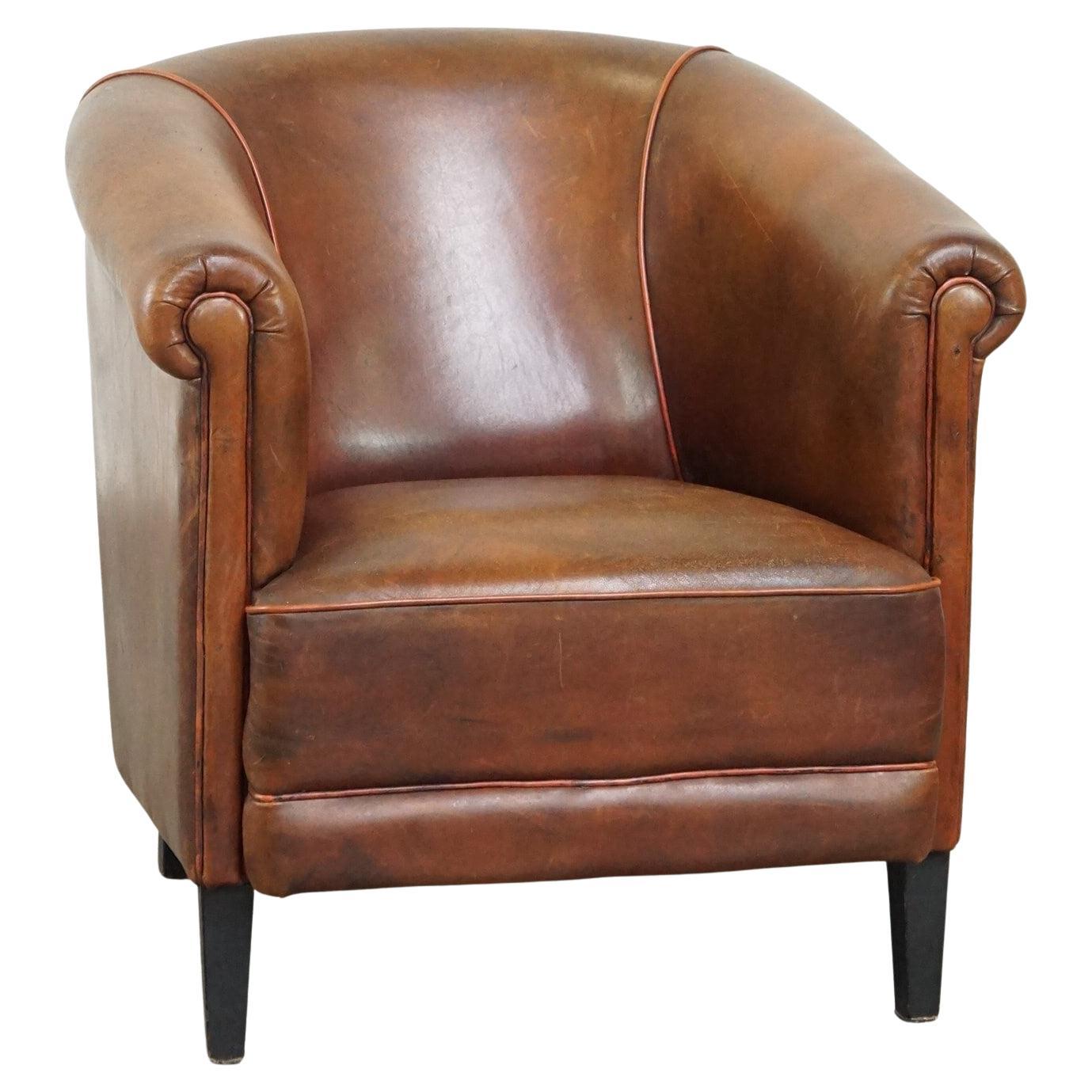 Neat, elegantly finished, cozy sheepskin club armchair with a fixed seat cushion