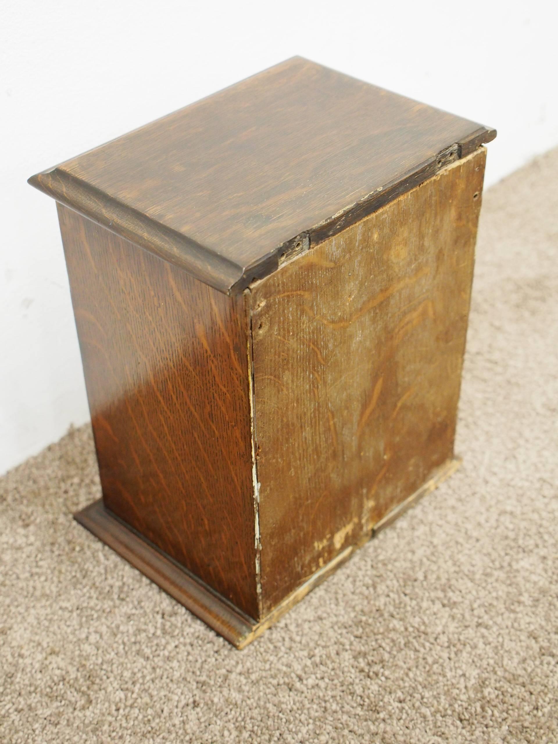 Neat oak and brass Victorian country house or hotel letter box, circa 1880, with a solid top and ogee moulded fore-edge, there is a brass plaque stating ‘letters’, and beneath is large oak door with classic brass strap hinges with Gothic tracing.