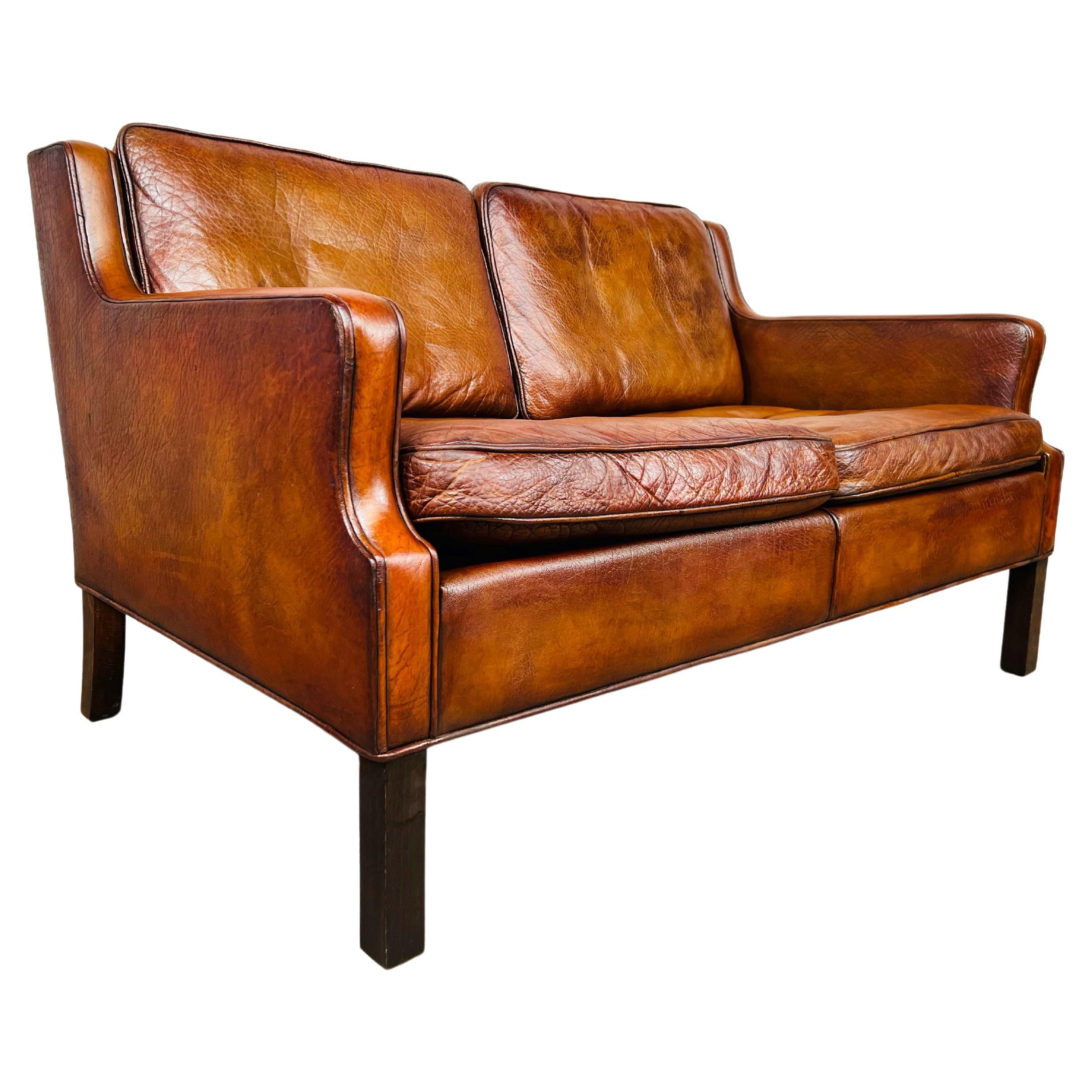 Neat Vintage Danish 1970s Patinated Tan Two Seater Leather Sofa For Sale