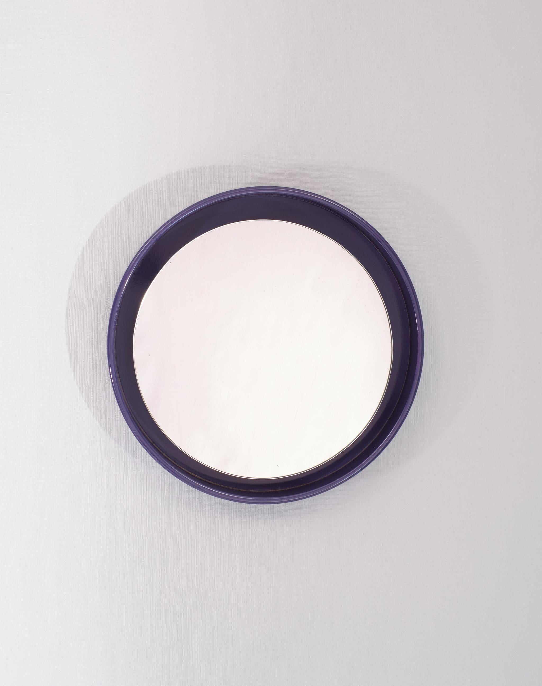 Very nice Round  Mirror .Purple color . The mirror itself is a little off center
Its  intended . Very good quality . Signed Nebu Holland 