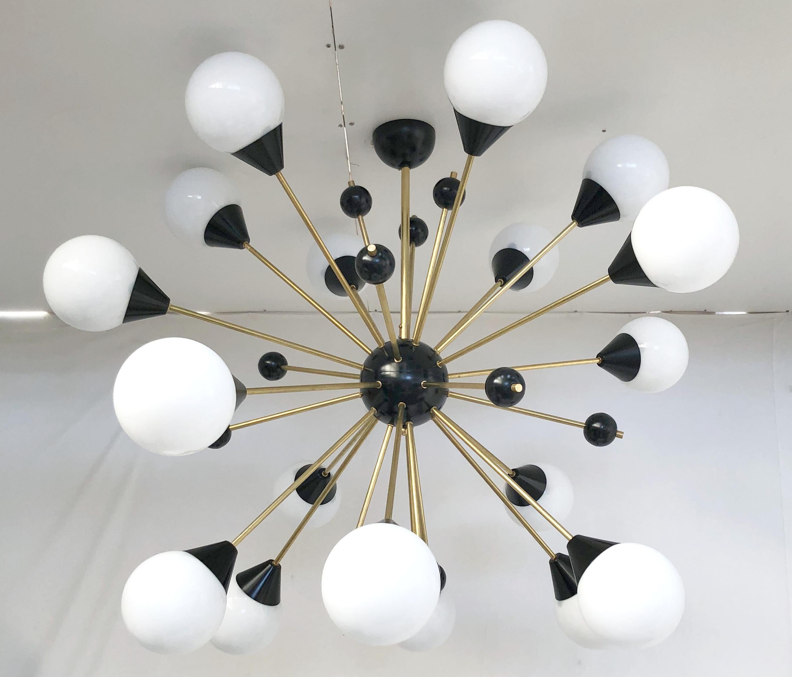 Italian midcentury style Sputnik chandelier with 18 glossy white Murano glass globes on unlacquered natural brass stems, with small black decorative globes, black center and ceiling canopy / designed by Fabio Bergomi for Fabio Ltd, made in