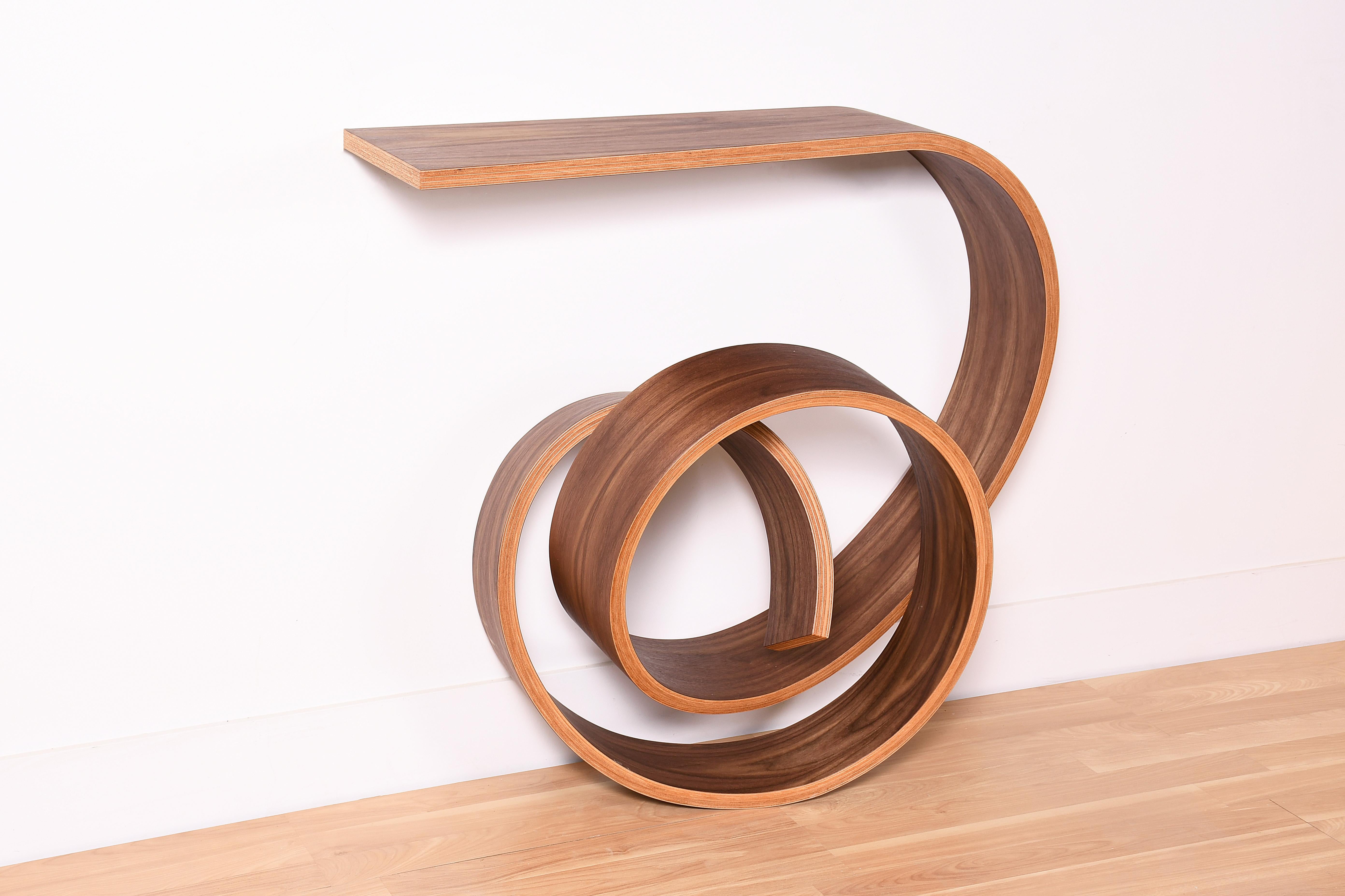 This extraordinary console table has been bent into a knotted form, it’s the result of many years of research on the technique of bent lamination. It’s my second best selling piece since a few years now. I’ve made several ones with different woods