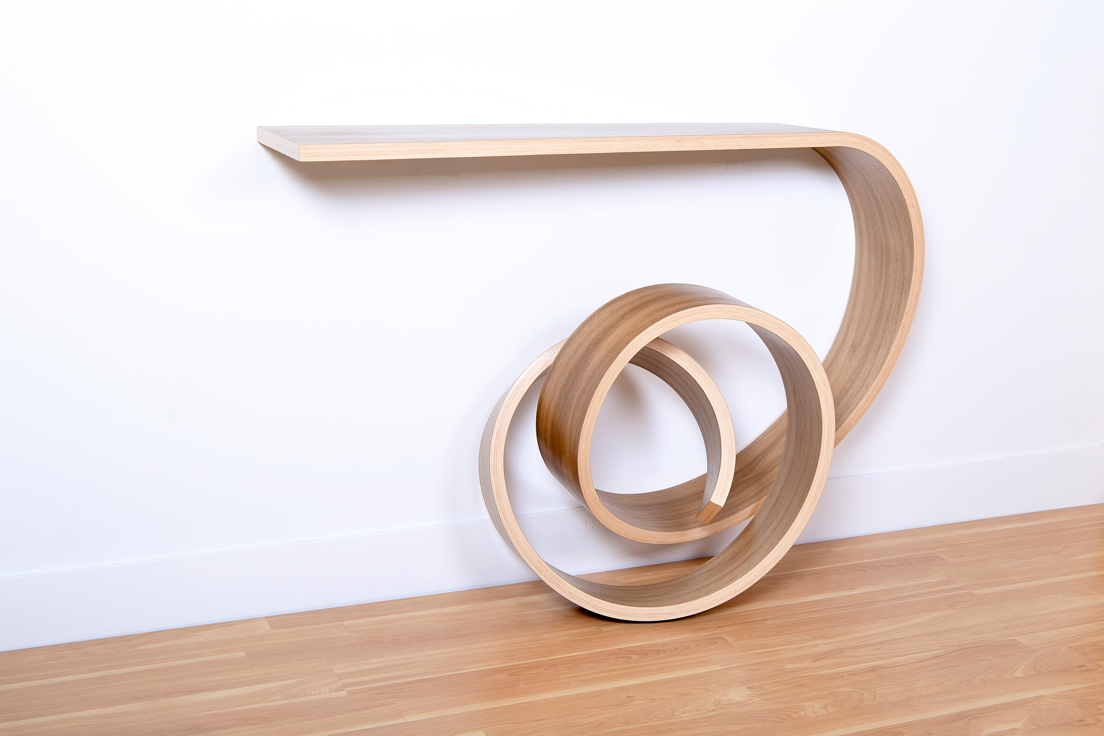 This extraordinary console table has been bent into a knotted form, it’s the result of many years of research on the technique of bent lamination. It’s one of my best selling pieces since a few years now. I’ve made several ones with different woods