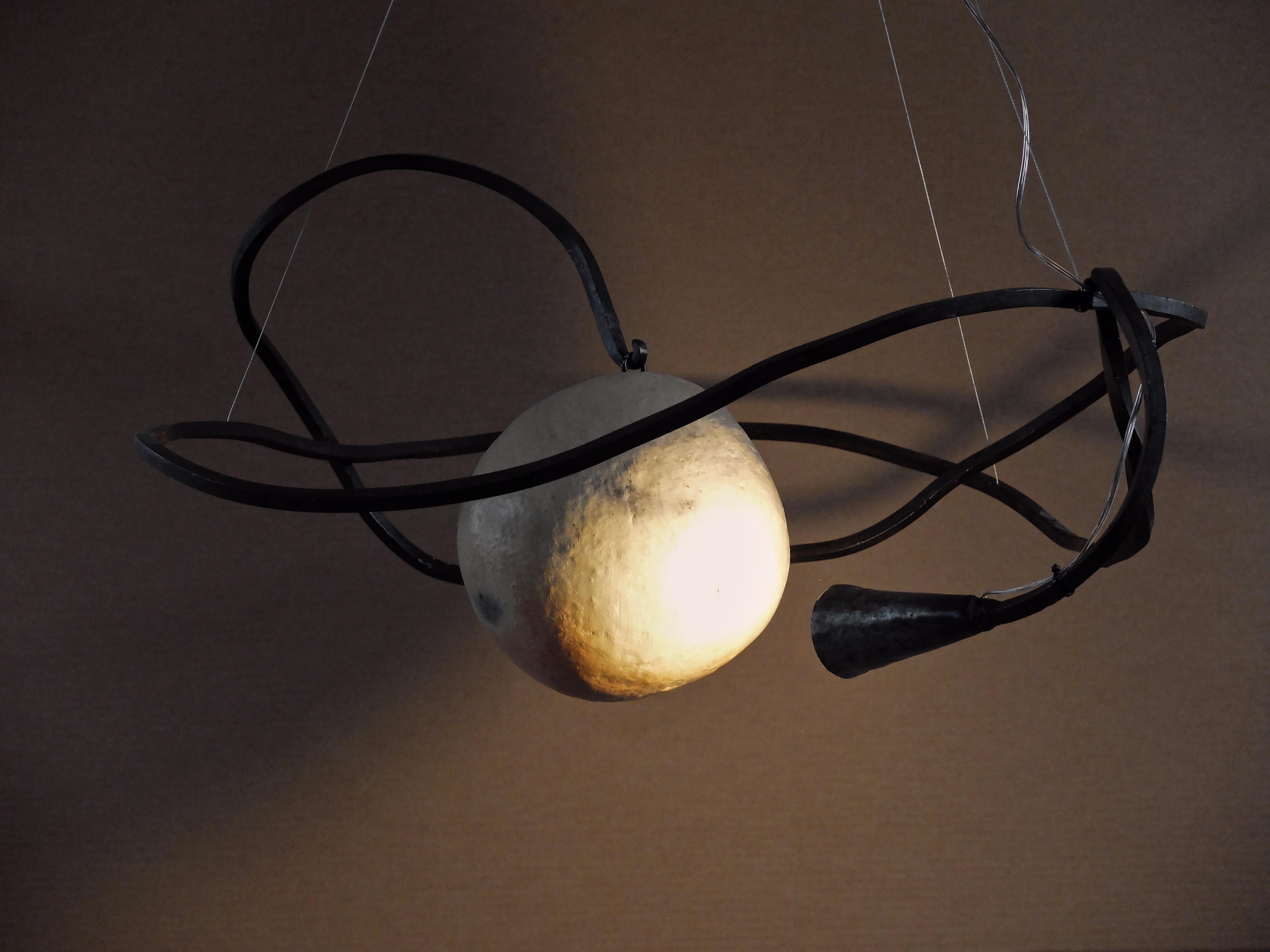 Nébuleuse Pendant Lamp by Altin
Designed and developed by Yasmine Sfar and Mehdi Kebaier.
Dimensions: D 90 x W 95 x H 35 cm
Materials: Metal, ceramic.

Earth and metal suspension light.

Orbit
A journey to a new dream world that we could call
