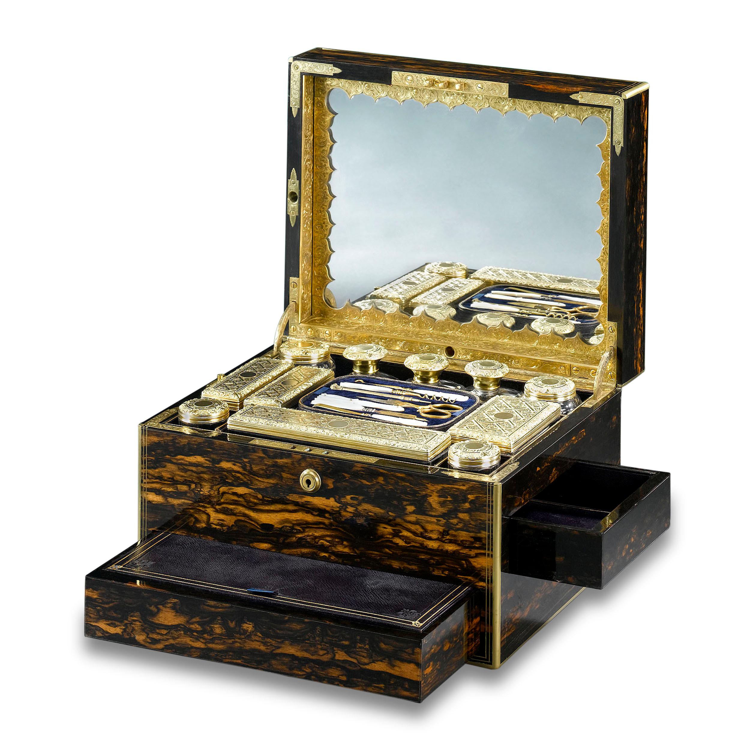 This elegant English nécessaire de voyage is veneered with rich coromandel wood with brass inlay. It is protected by rare Bramah locks, making it impeccably suited for carrying everything a person of nobility would need while traveling. The inside