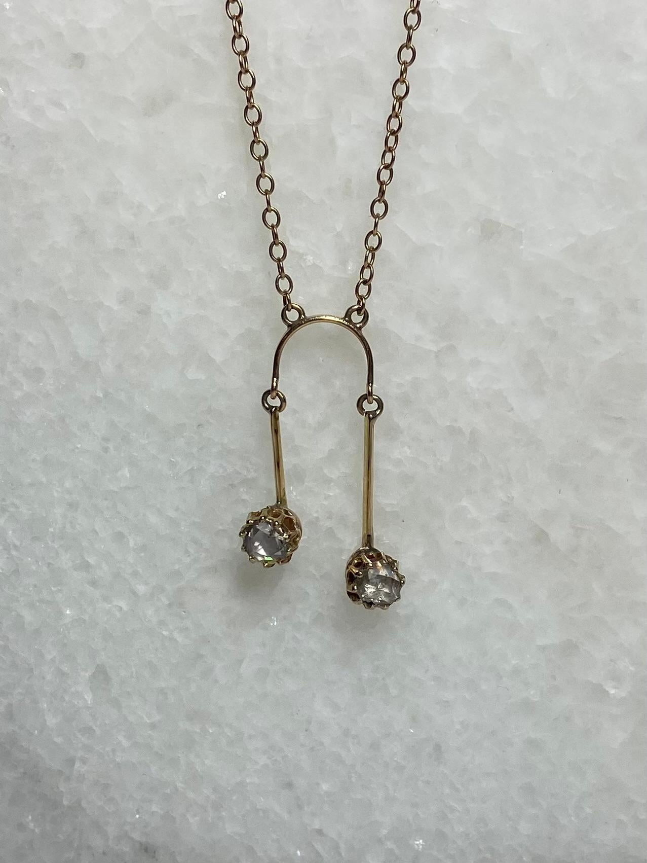 Pre-loved Necklace 14 carat gold toi&moi with rose cut diamonds with 0.24 carat.

This is a gorgeous necklace from the 1950S with a bow shaped middle part. The middle part has 2 bars set with 2 rose cut diamonds with a carat of about 0, 12 each. The