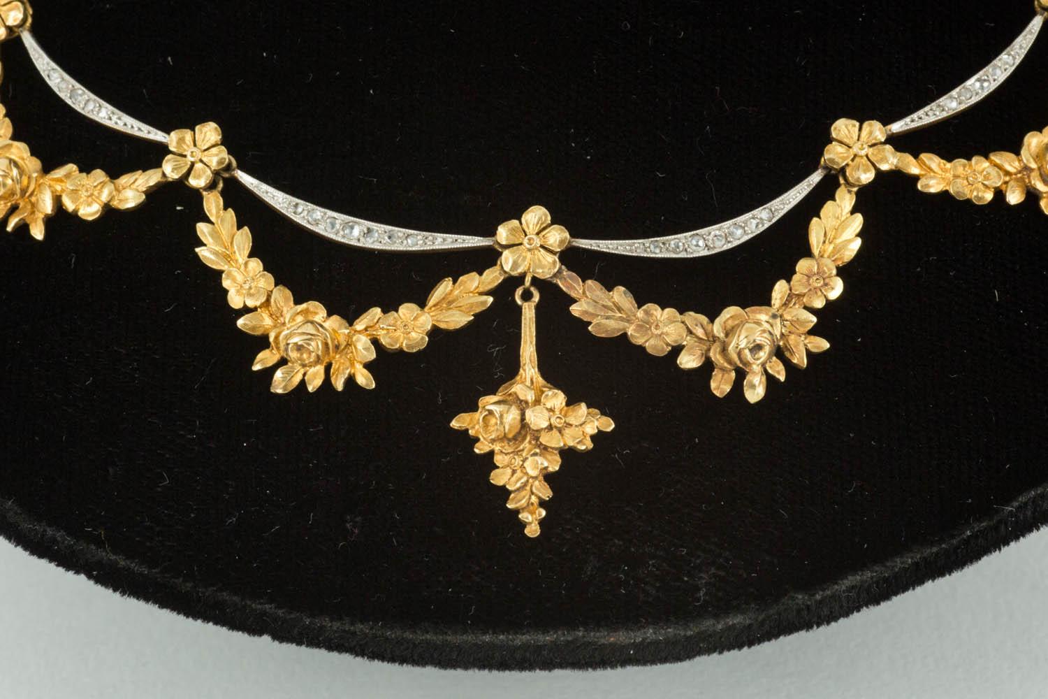 A finely carved 18 carat gold floral Necklace of roses,buds and leaves,with four crescents within, set with rose cut diamonds French circa 1900