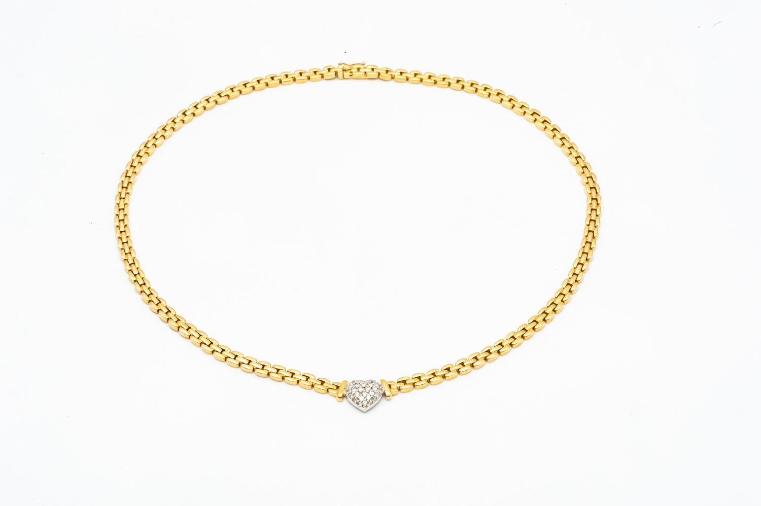 18 karat yellow gold and 18 karat white gold diamond heart necklace 

18 karat yellow gold and 18 karat white gold heart necklace. 20 diamonds are encrusted in the heart. Ideal for a gift. 

20 Diamonds : 0,03 caratx20 = 0,60 carats