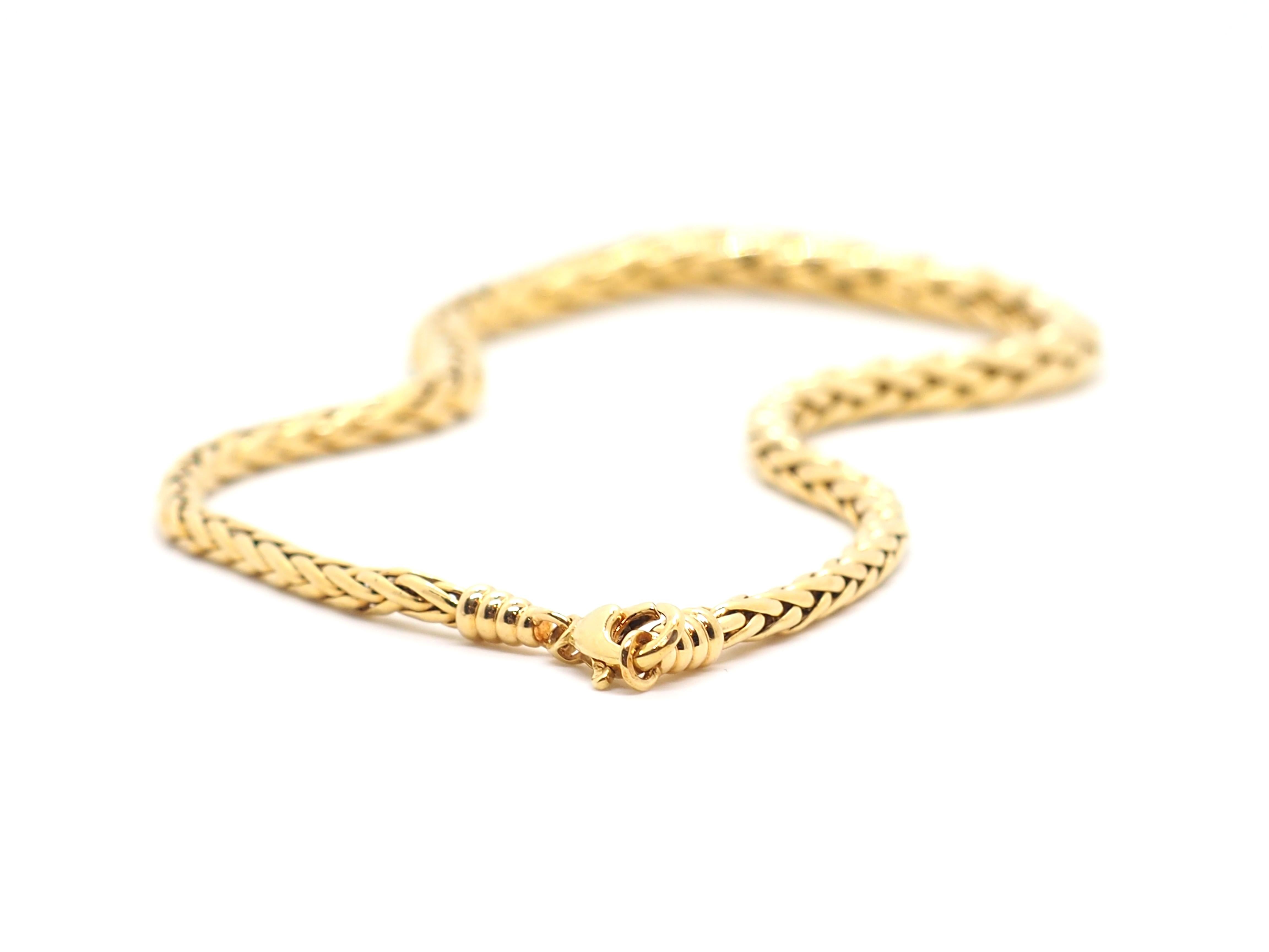 Wheat necklace made of 18 Karat yellow gold. This necklace is wider in the center part and narrower towards the side. 
This exquisite gold chain necklace is made of 18 karat gold, ensuring superior quality and durability. 
The necklace features a
