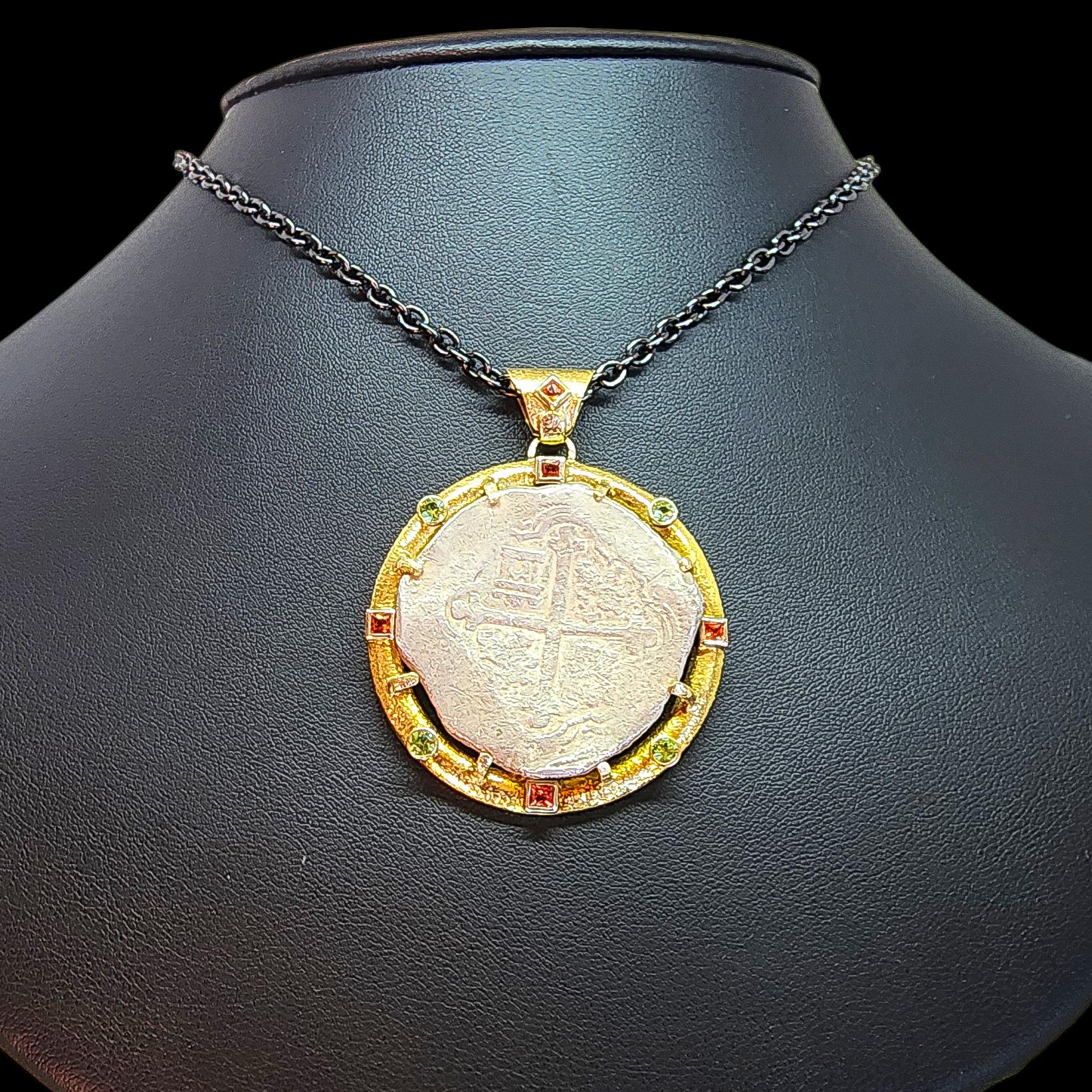 One of a Kind, Entirely Hand Made, Men's Ancient Coin Pendant with Sapphires and Tsavorite Garnets.
The Pendant is crafted in solid 18K Yellow Gold and features as its center piece, an authentic (Certified by the Numismatic Guaranty Corporation),