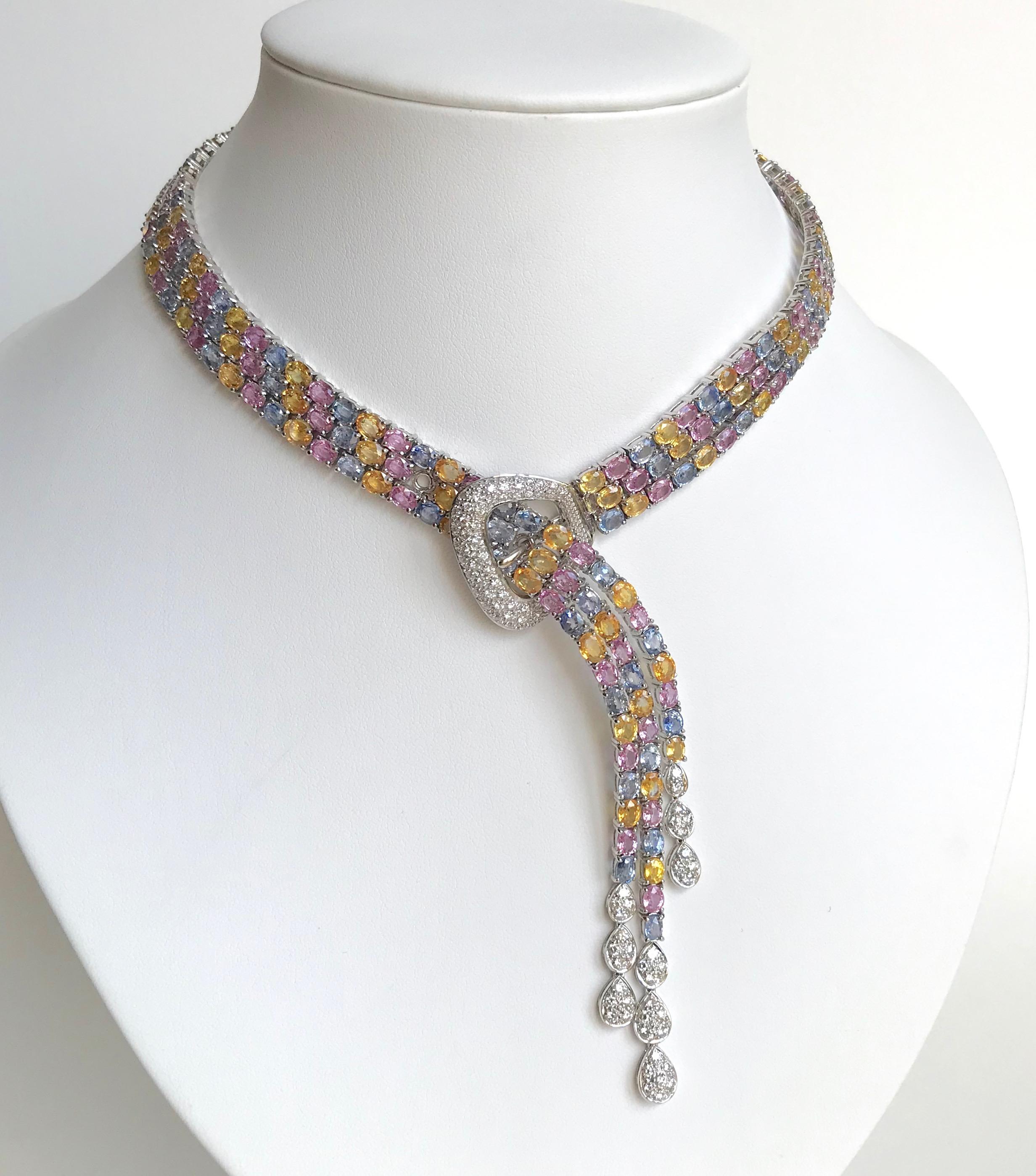 Necklace Flexible Belt in 18 carat White Gold setting 80 Carats of multicolored Pink, Yellow and Blue Sapphires in 3 Rows and 2.38 Carats of Diamonds. The End of the Belt separates into 3 Rows ending with 3 Droplets Drops set with Diamonds
The Belt