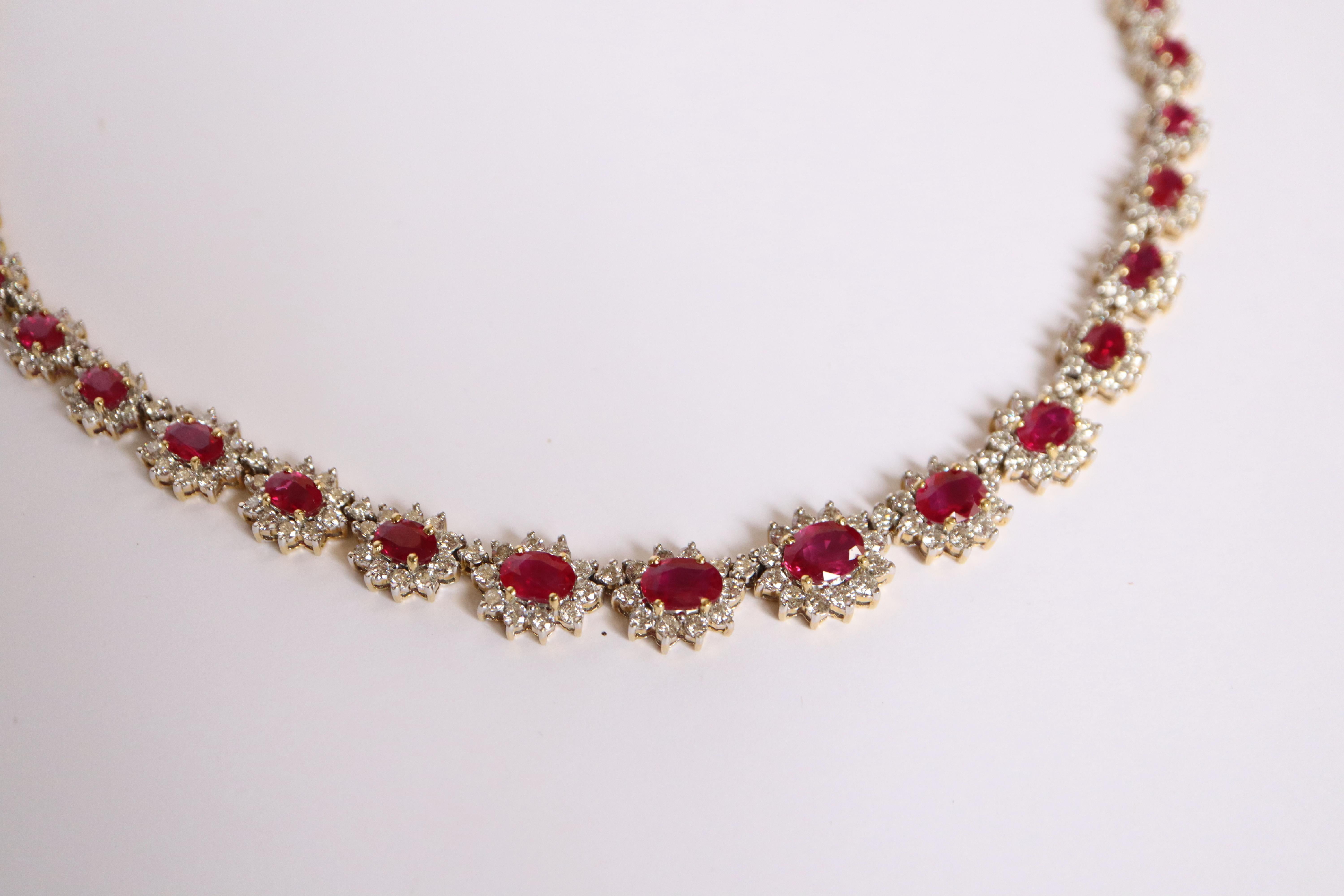 Drop necklace in 18k white and yellow gold, rubies and diamonds. It is composed of 45 daisy motifs each adorned with a central ruby ​​surrounded by diamonds. Setting in 18 kt white gold for the diamonds and in 18 kt yellow gold for the claw setting