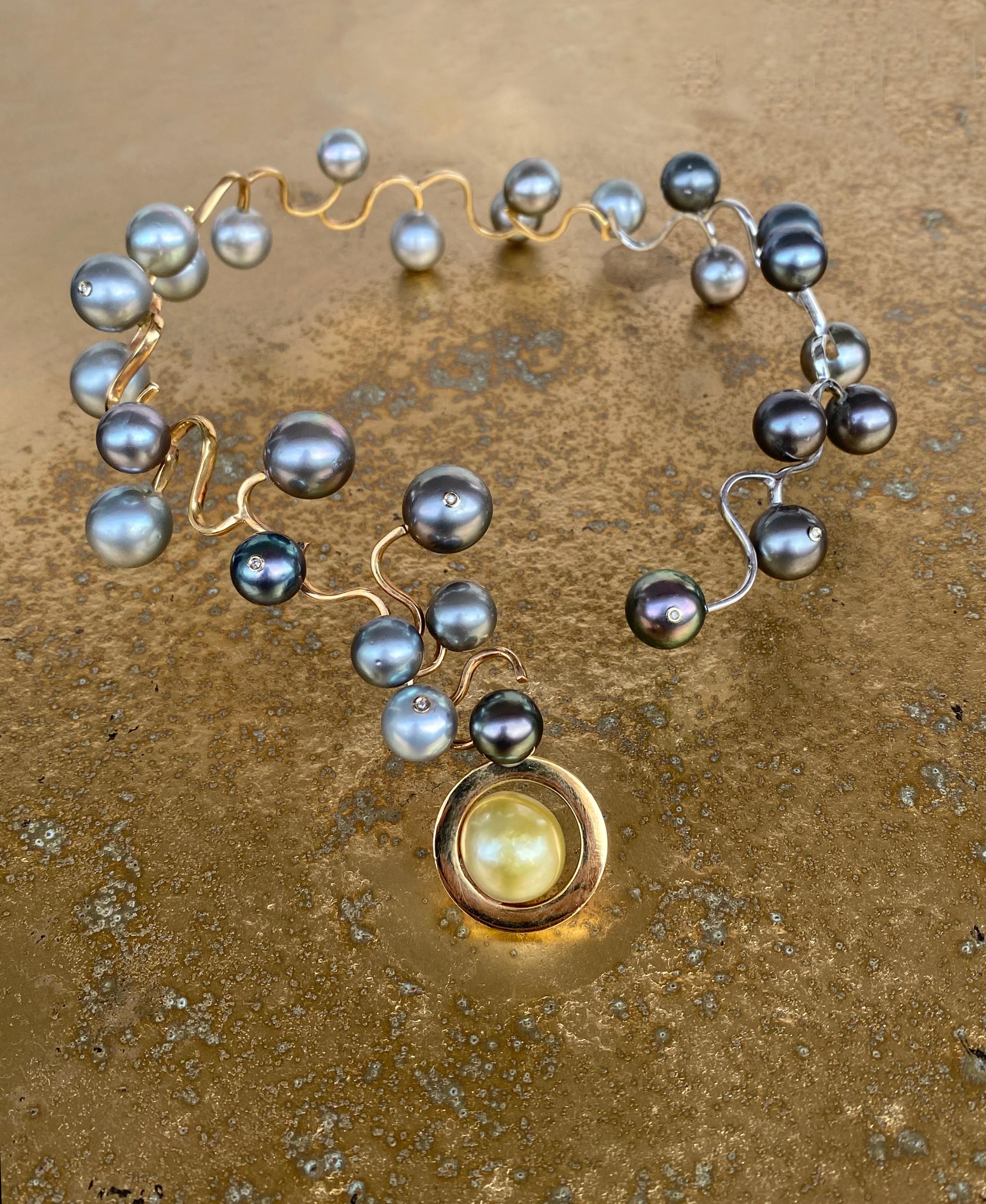 This One of a Kind Statement Tahitian Pearls and Diamonds Necklace, in 18 Karat Yellow and White Gold, is a high jewelry Award Winning Design.  This precious pearls and diamonds necklace evokes a Galaxy as it plays with its colors and shapes. In