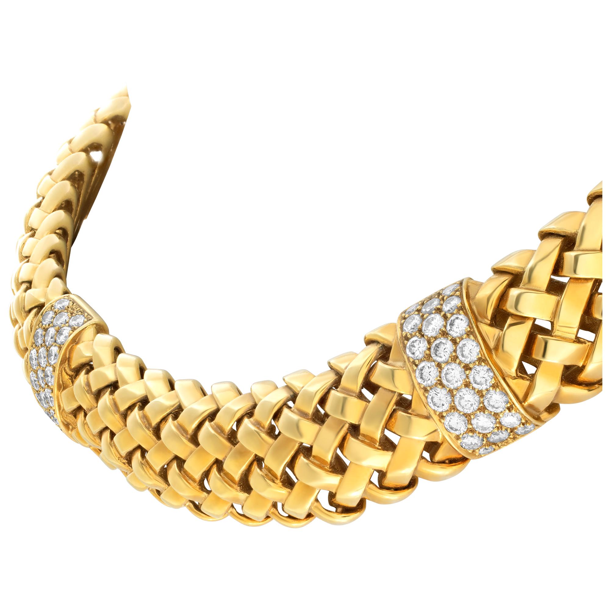 Tiffanny & Co. Vannerie collection necklace in 18K yellow gold. Stunning woven link designed with 2 stations pave set with 38 full cut round brilliant diamonds totalling approximately 1.85 cts in F color, VS clarity diamonds. Length is 19