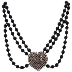 Vintage Necklace made of Gablonz glass beads with rhinestone heart