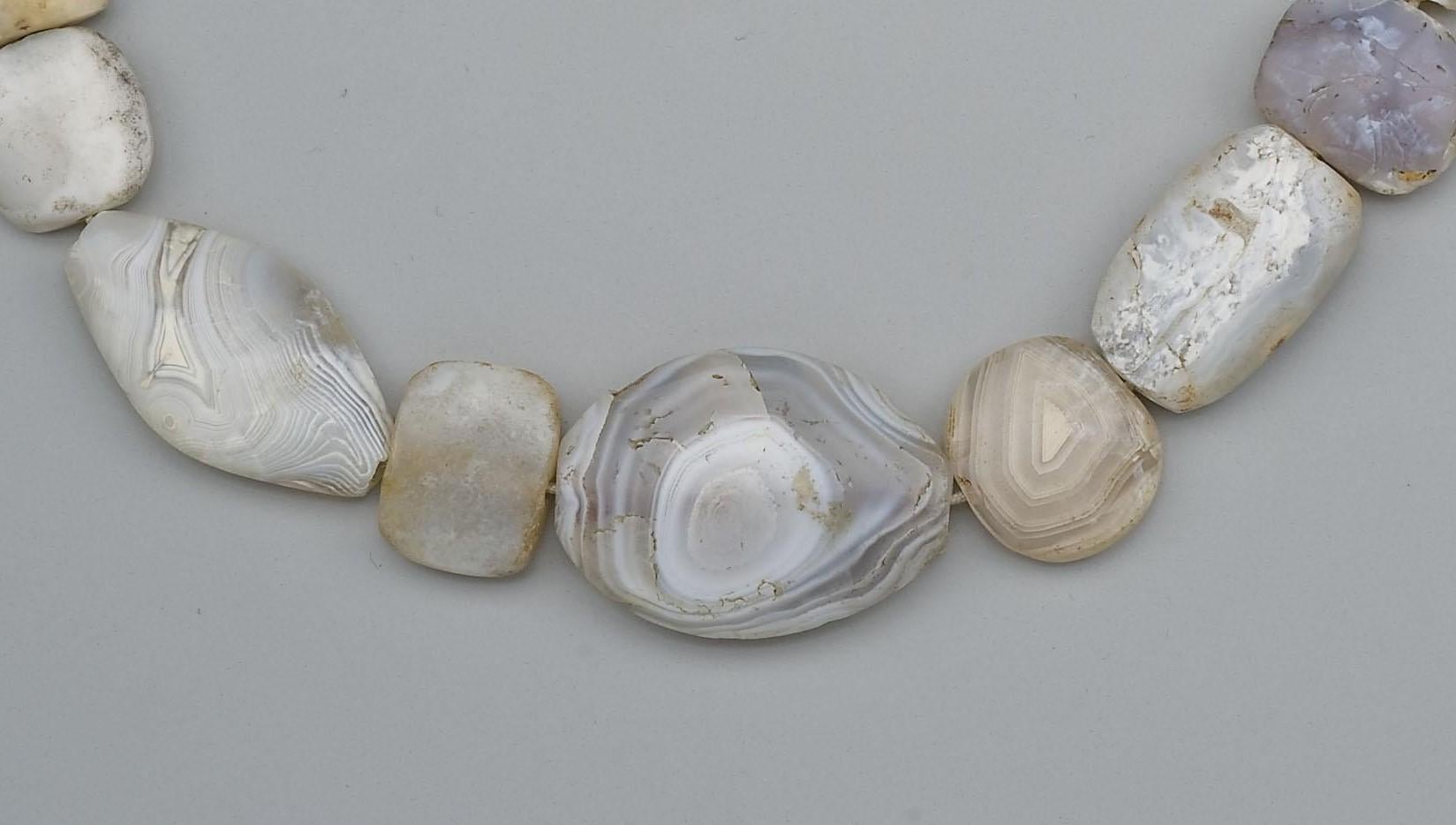 Twenty-four large agate beads of flattened shapes from the Bronze Age (approximately four thousand years ago). The dimensions of the beads are as follows (clockwise from the top):
1. Length 3 cm, width at center 1.79 cm, width at ends 1.2 cm,