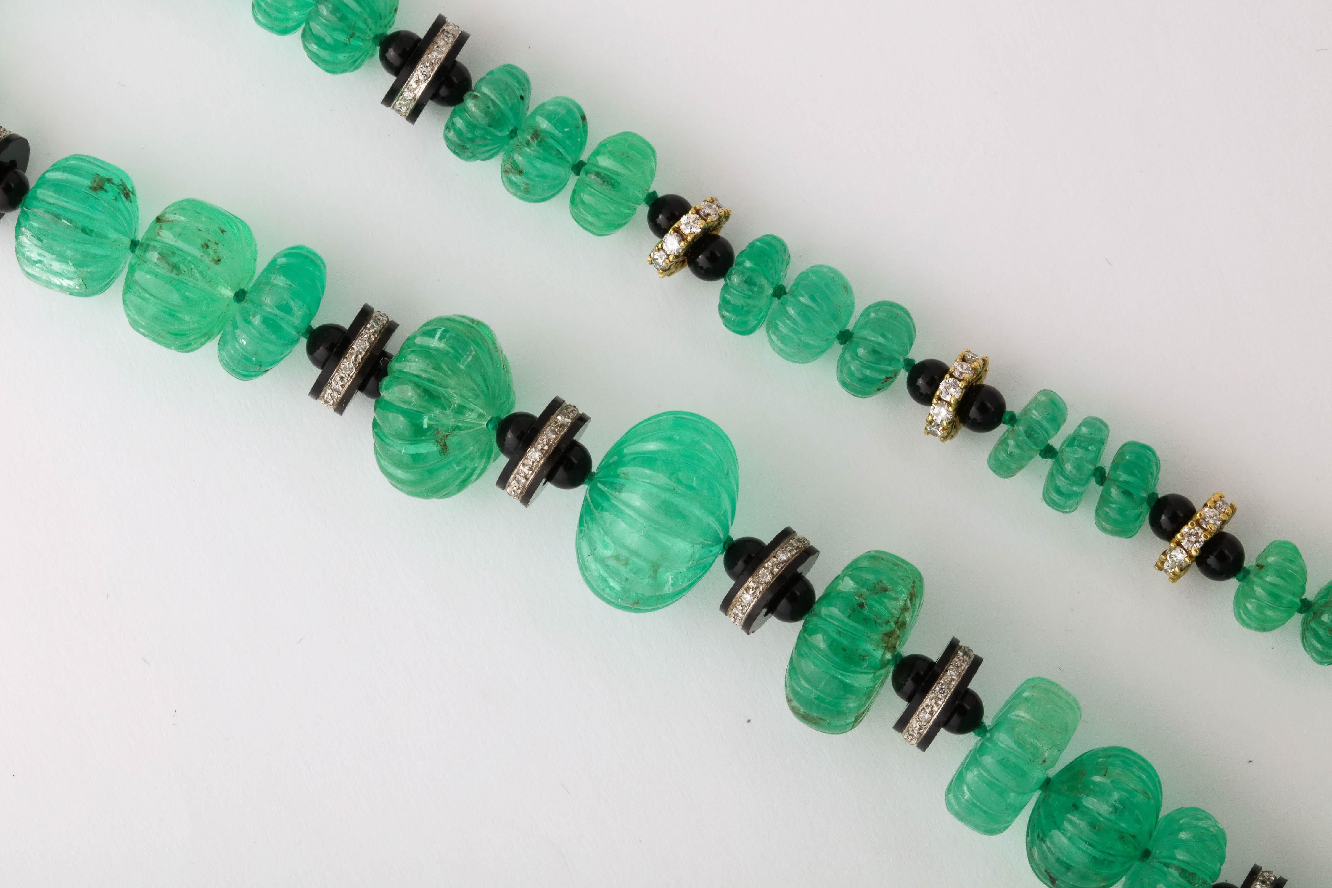 Necklace of Graduated Melon Shaped Emerald Beads with Onyx and Diamond Spacers In Excellent Condition In New York, NY