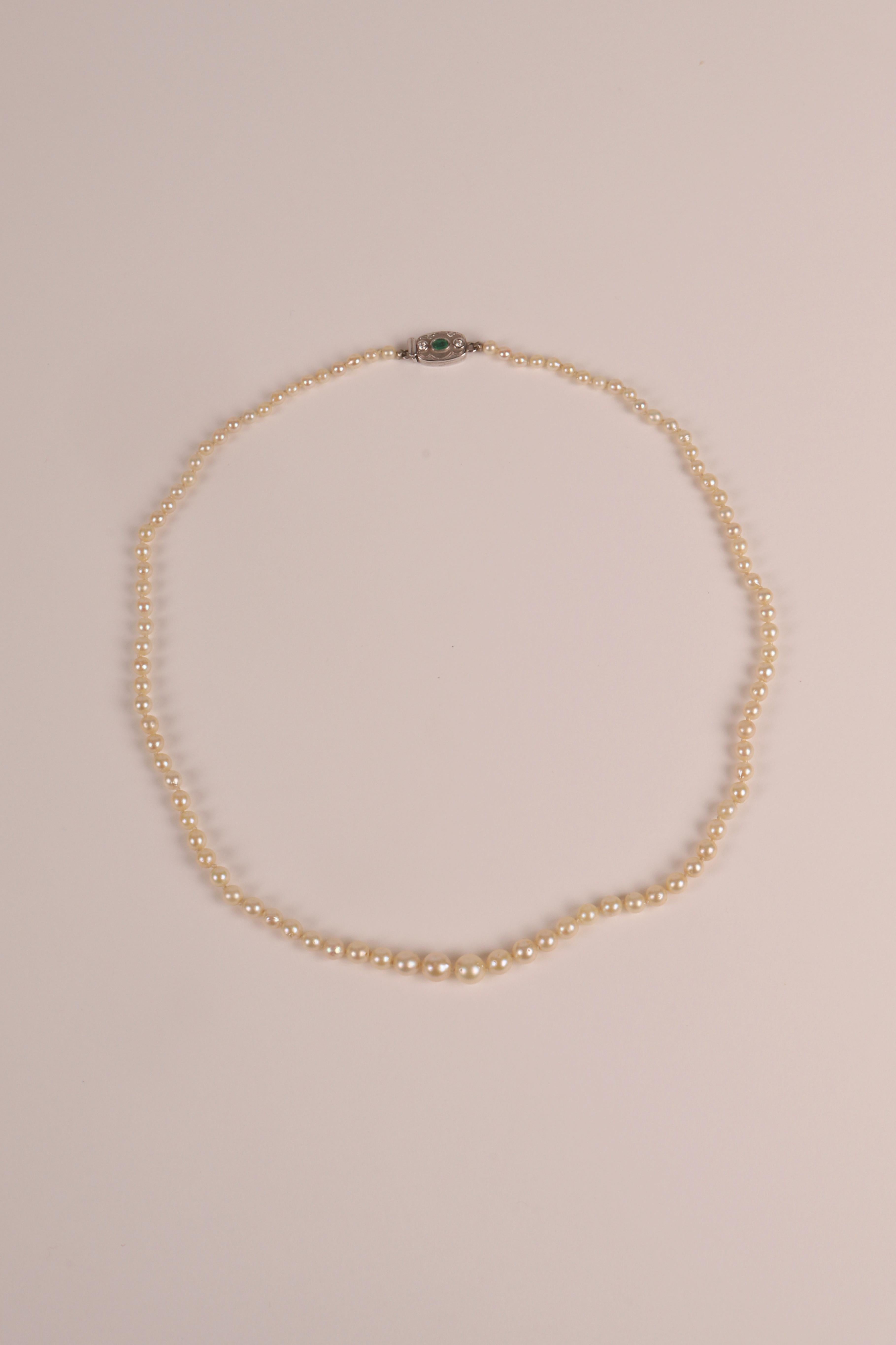 20th Century Necklace of natural pearls with gold, emerald and diamonds clasp. Austria 1910. For Sale