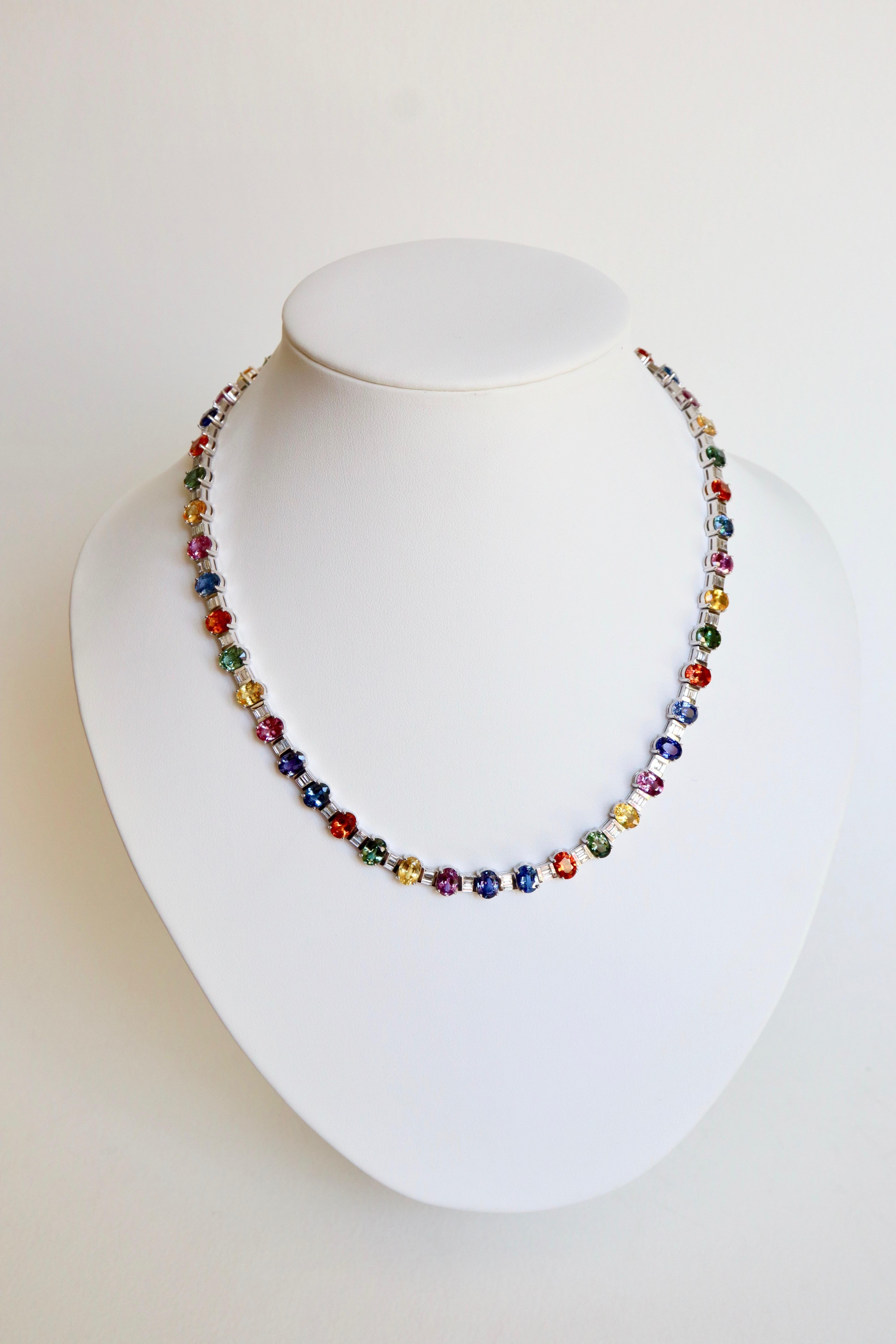 Necklace in 18 Carat white Gold composed of 48 Beautiful Multicolored Sapphires alternated with Baguette Diamonds.
Security clip. 
Hallmark of Eagle
Length: 45.5 cm Width: 7 mm
Sapphires Weight: 53 carats Dimension of sapphires: 7 mm x 5 mm
Weight