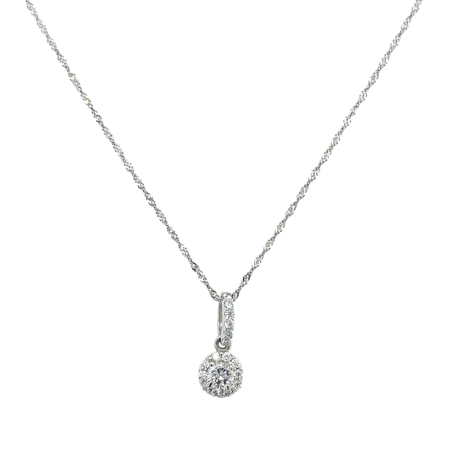 This necklace set features 0.30 natural Round Brilliant Cut Diamonds in a halo setting. The Diamonds are set in 18ct White Gold, and total length of the necklace is 18 inches. It is perfect for any occasion and is a great gift for a loved
