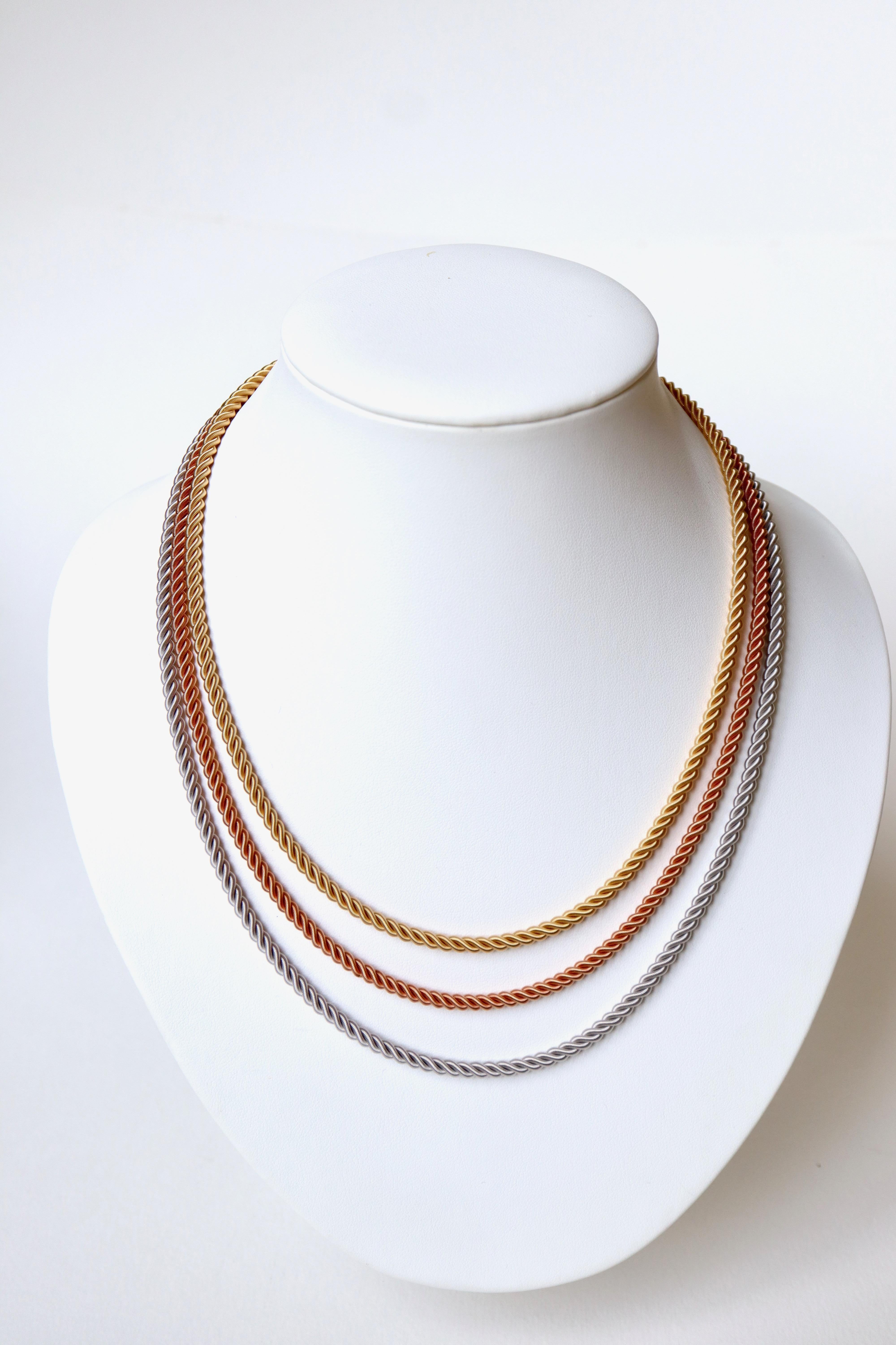 Necklace three Gold 18 kt composed of three Rows in fall of three Twists. One cable in yellow gold, one cable in pink gold, one cable in white gold. Each twist is made up of three coiled and twisted threads.
Length: 46 to 53 cm 
Width of each cable: