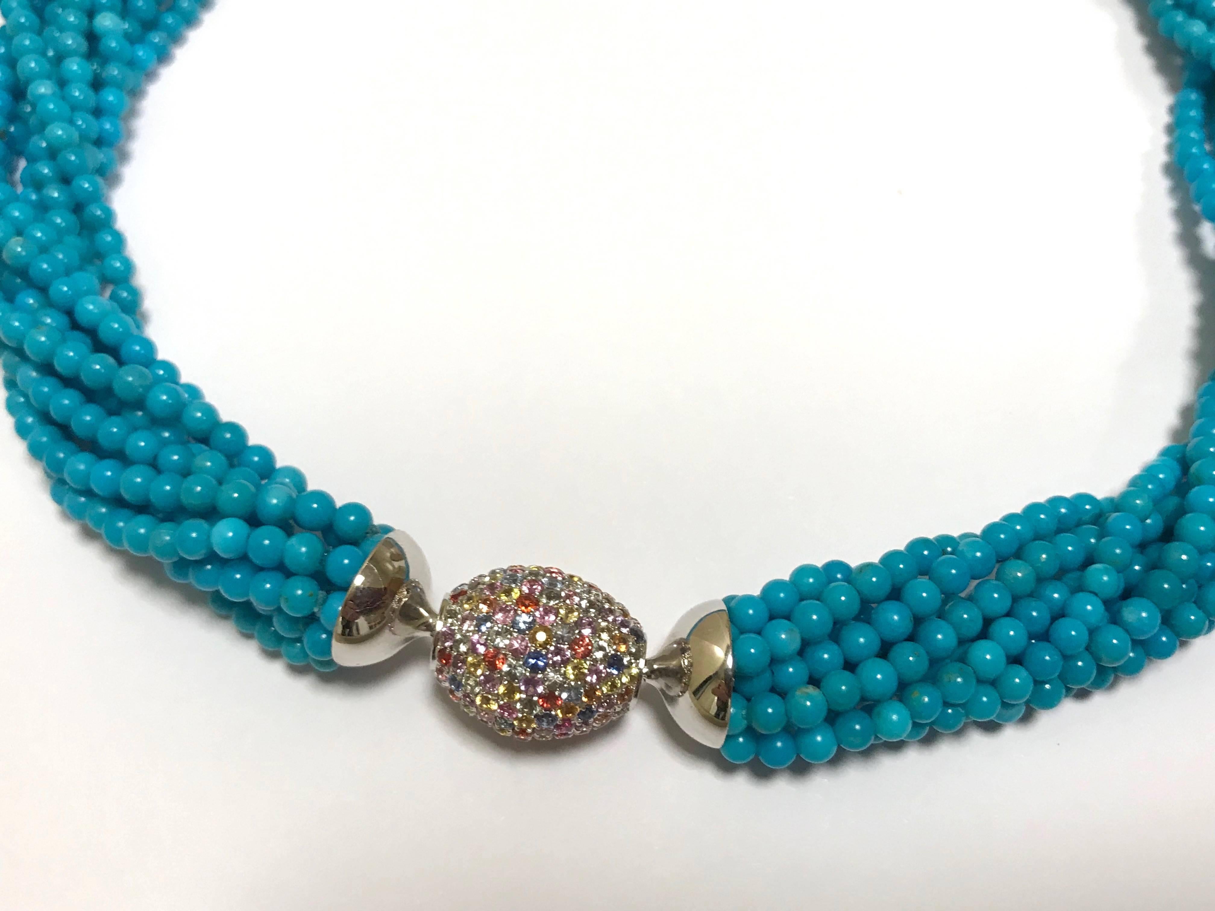 An exceptional multi-strand turquoise necklace, enhanced by the sparkling brilliance of 66 fancy sapphires, magnificently arranged on a removable clasp in 18-carat white gold. This refined piece of jewellery is a true masterpiece of craftsmanship