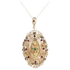 Necklace with 18 carat yellow gold pendant with diamonds, rubies and emerald