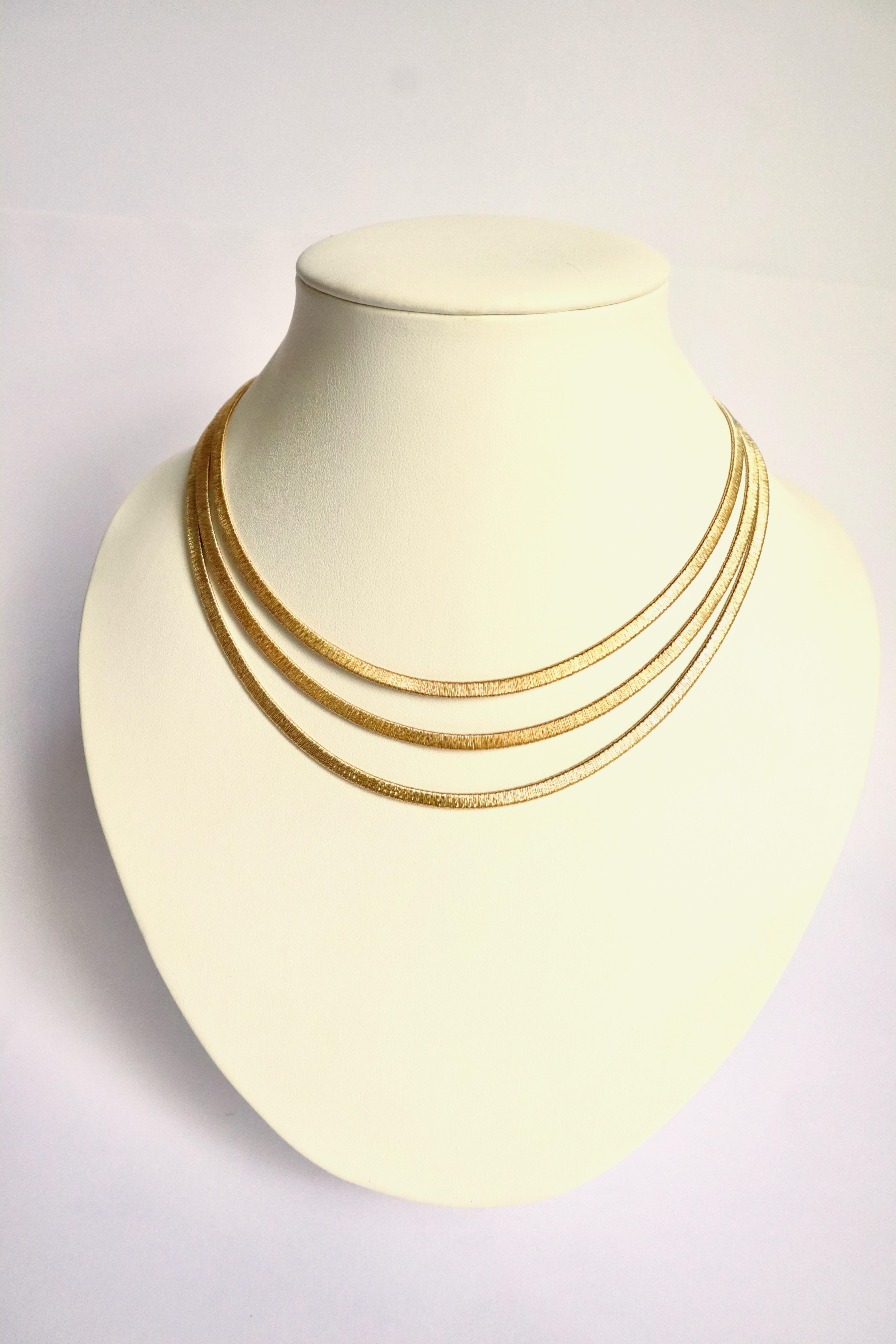 Necklace 3 flexible gold wires in 18 kt yellow gold. Each wire is composed of a yellow gold wire wound on a flexible gold mesh frame. 
Tongue clasp with security eight. 
Weight: 41g. 
Eagle's head hallmark. 
Length: 41 for the shortest row to 45 cm