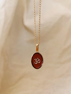 Necklace with amber pendant and Om symbol gold
