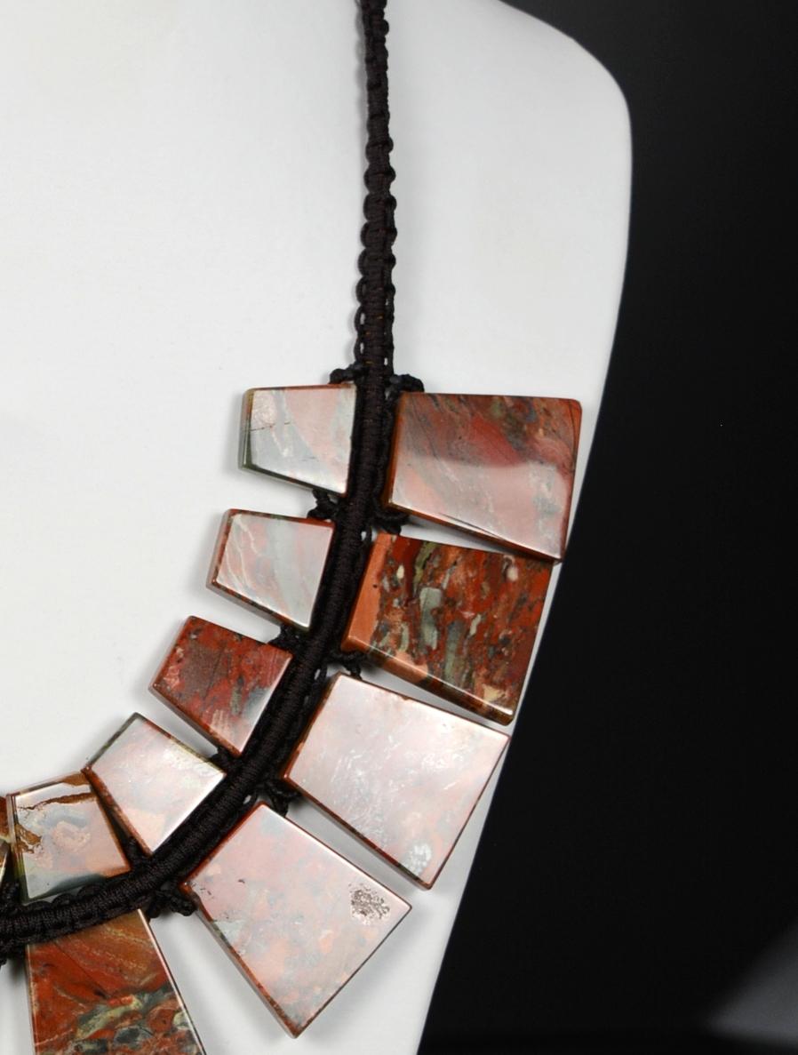 Jasper plated necklace.
Black cord necklace that has been used to position and join the rectangular jasper plates that make up the necklace, these wider at one end than the other. Jasper, used for jewelry and other sumptuary arts since Antiquity,