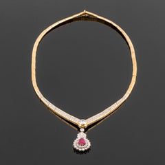 Cocktail necklace in gold and diamonds, large central diamond and rubi pendant