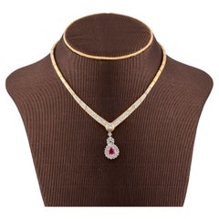 Cocktail necklace in gold and diamonds, large central diamond and rubi pendant
