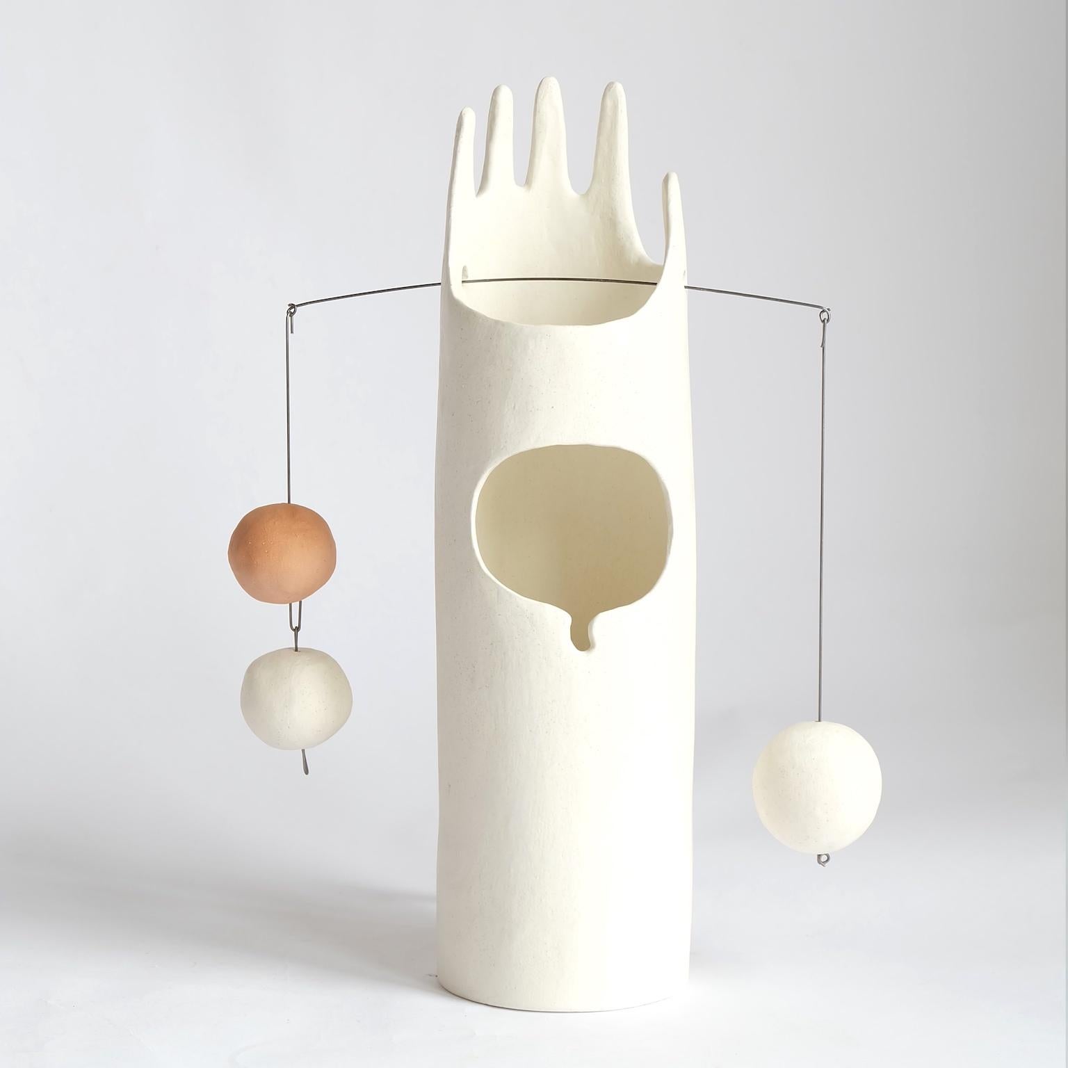 Rico's Cousin Neco is a contemporary hand-built sculptural ceramic table lamp that inspires the joy of working with hands through unpacking, assembling and balancing weights. The handmade ceramic globes and the hanging steel wire come fit right