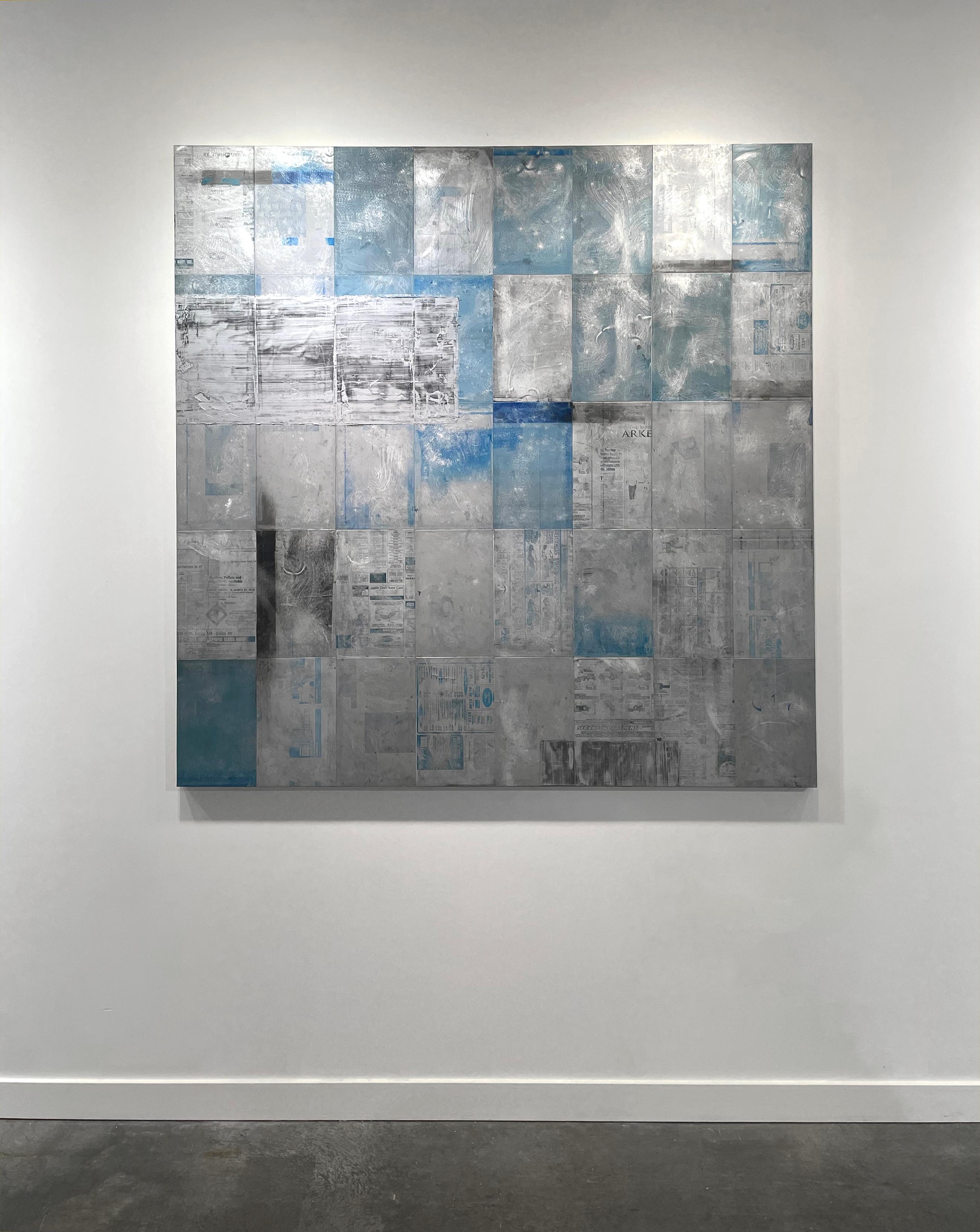 This abstract painting by Ned Martin is made with oil paint and recycled aluminum on board. It features a grid composition with a light layers of blue, black, and silver paint, with used recycled printing plates showing through. This large-scale