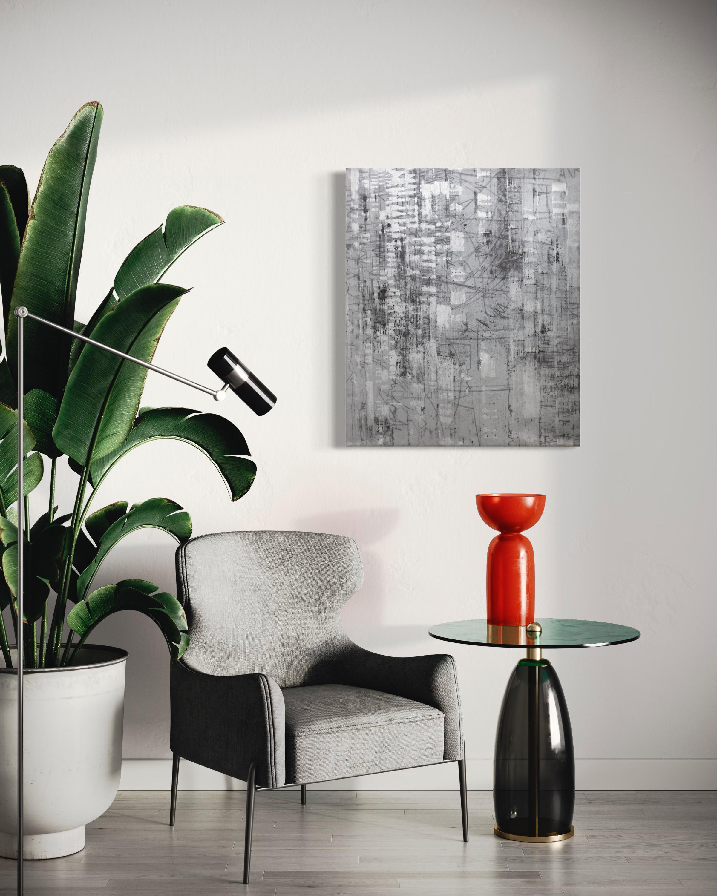 This abstract geometric painting by Ned Martin is made with oil on gallery wrapped canvas and features a cool charcoal grey and metallic silver palette. It is signed by the artist on the back of the canvas and is wired and ready to hang in two