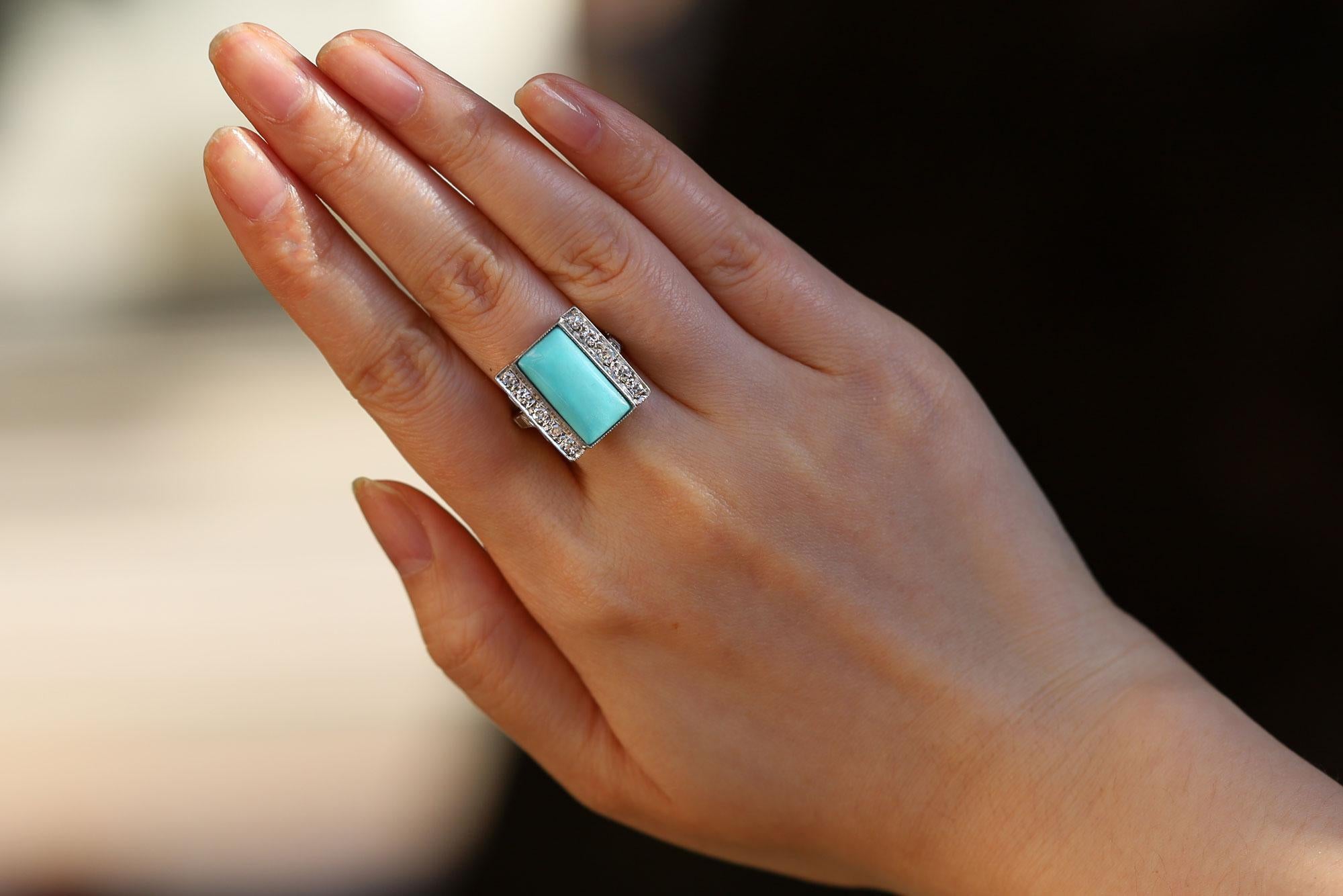 This antique cocktail ring was thoughtfully crafted during the Art Deco era of the 1920s. Its breathtaking Persian turquoise centerpiece creates the ideal, linear, geometric composition with a dreamy blue that complements all skin tones. Crafted of
