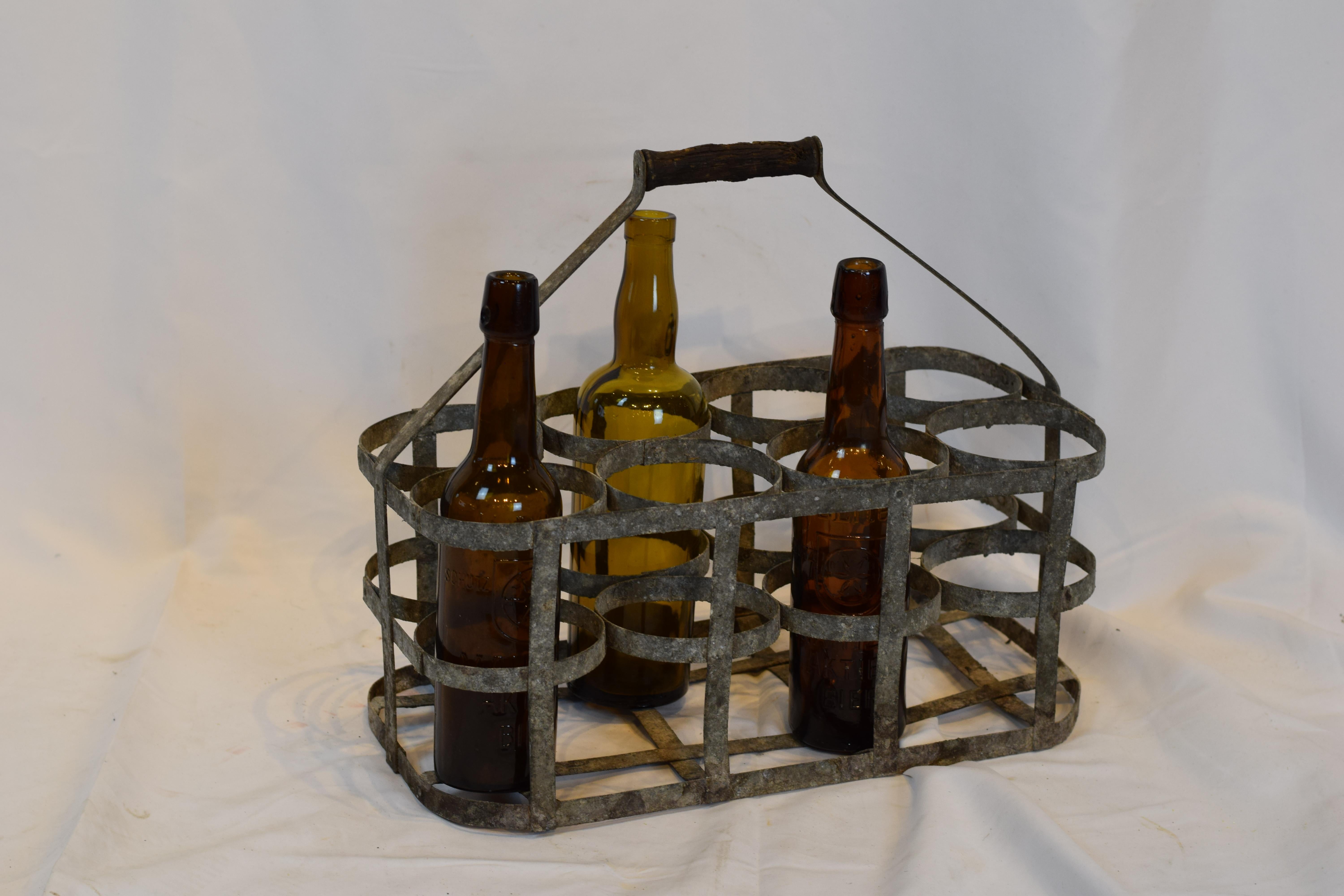 Early 20th century vintage French eight bottle wine carrier basket from France. Antique French handmade wine bottle carrier rack for 8 bottles, made of metal with a wooden handle. Used by the French for carrying wine bottles when going to the wine