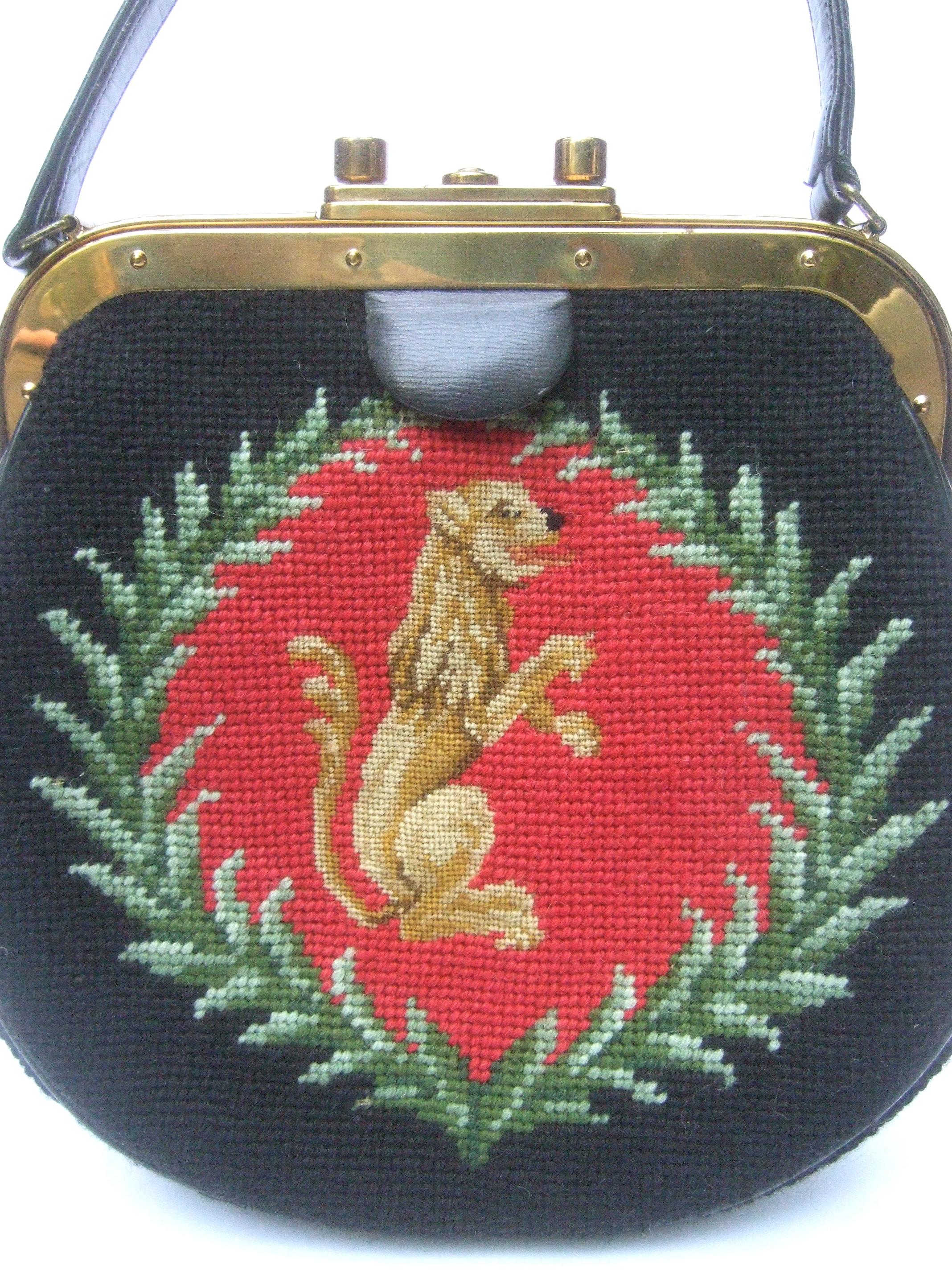 Elegant needlepoint artisan griffin & laurels vintage handbag c 1970
The chic retro needlepoint artisan handbag is decorated with an endearing griffin 
figure; surrounded with a wreath of laurels that is replicated on both exterior sides
Illuminated