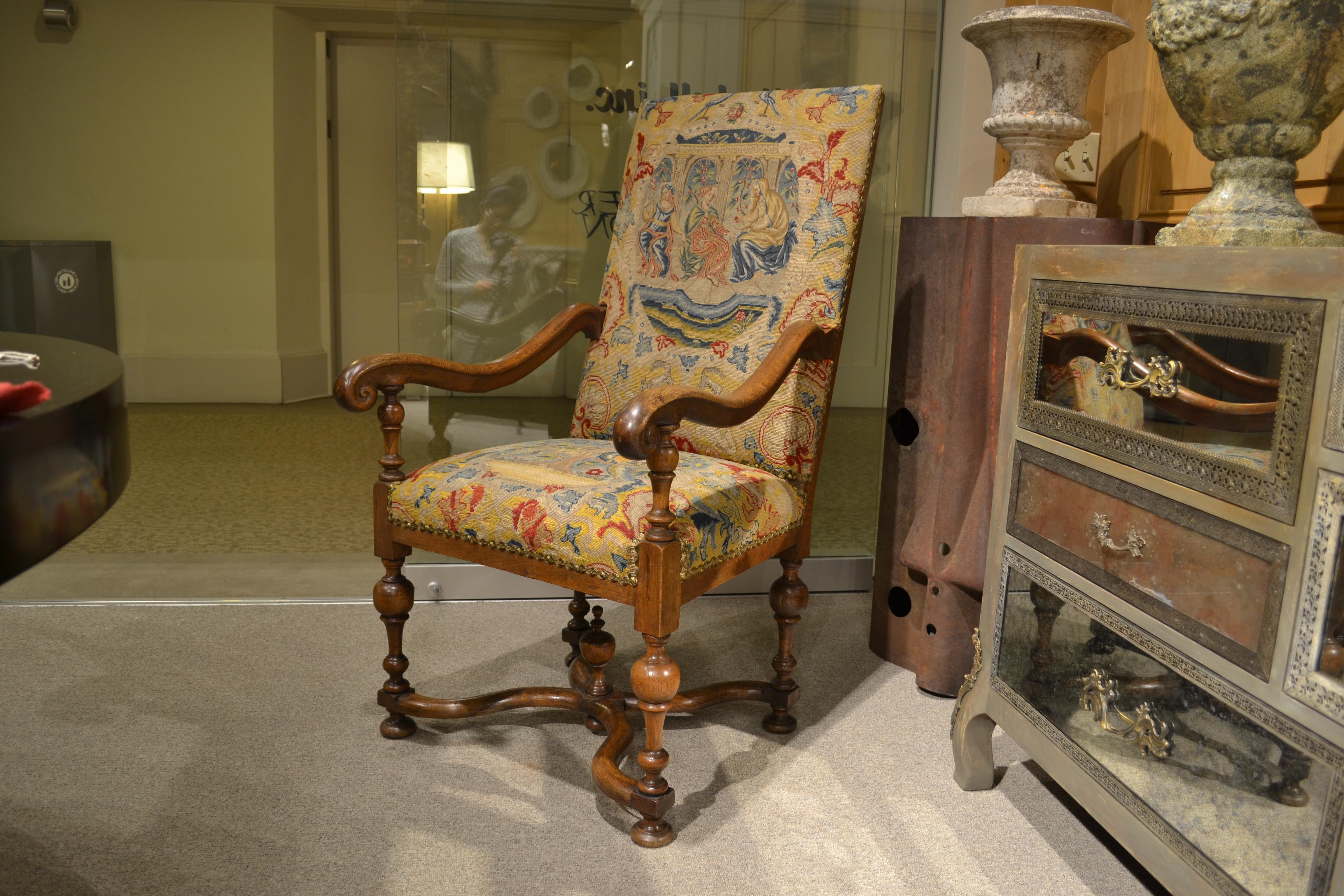 This decorative late 18th century Continental piece has a fine base with turned legs, shaped stretchers and finial. The shaped arms are comfortable and nicely proportioned. We have restored the chair, and removed, cleaned and reapplied the early