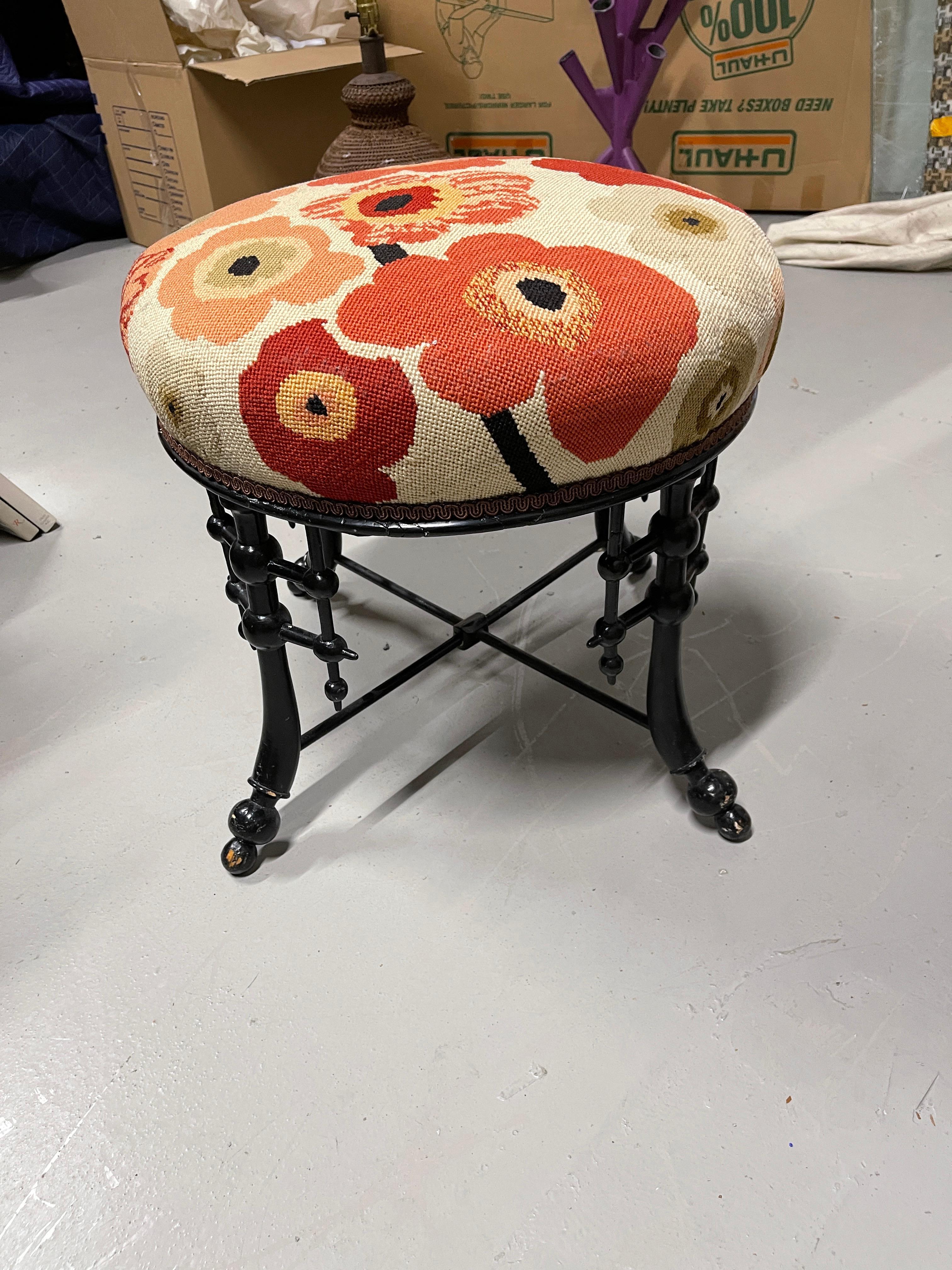 Wonderful needlepoint stool or ottoman with a faux bamboo wood base. Likely English, 19th century out of a wonderful Palm Springs Estate. In good overall condition, although there is paint loss to the feet and one of the struts, looks to have been