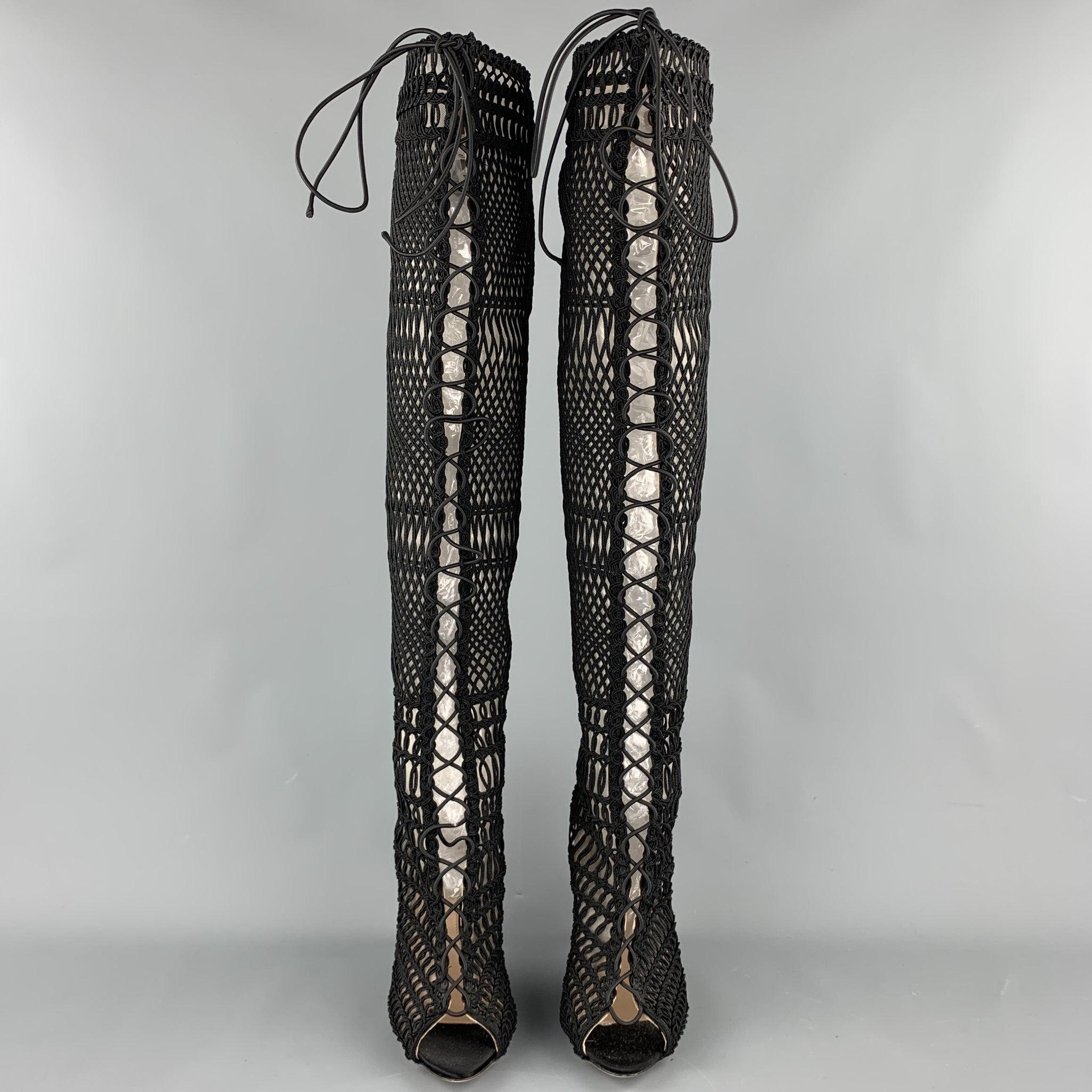 GIAMBATTISTA VALLI boots comes in a black knitted material with a mesh liner featuring a knee high style, suede trim, open toe, lace up, and a back zip up closure. Made in Italy.Very Good Pre-Owned Condition. 
Right boot repair at top interior.