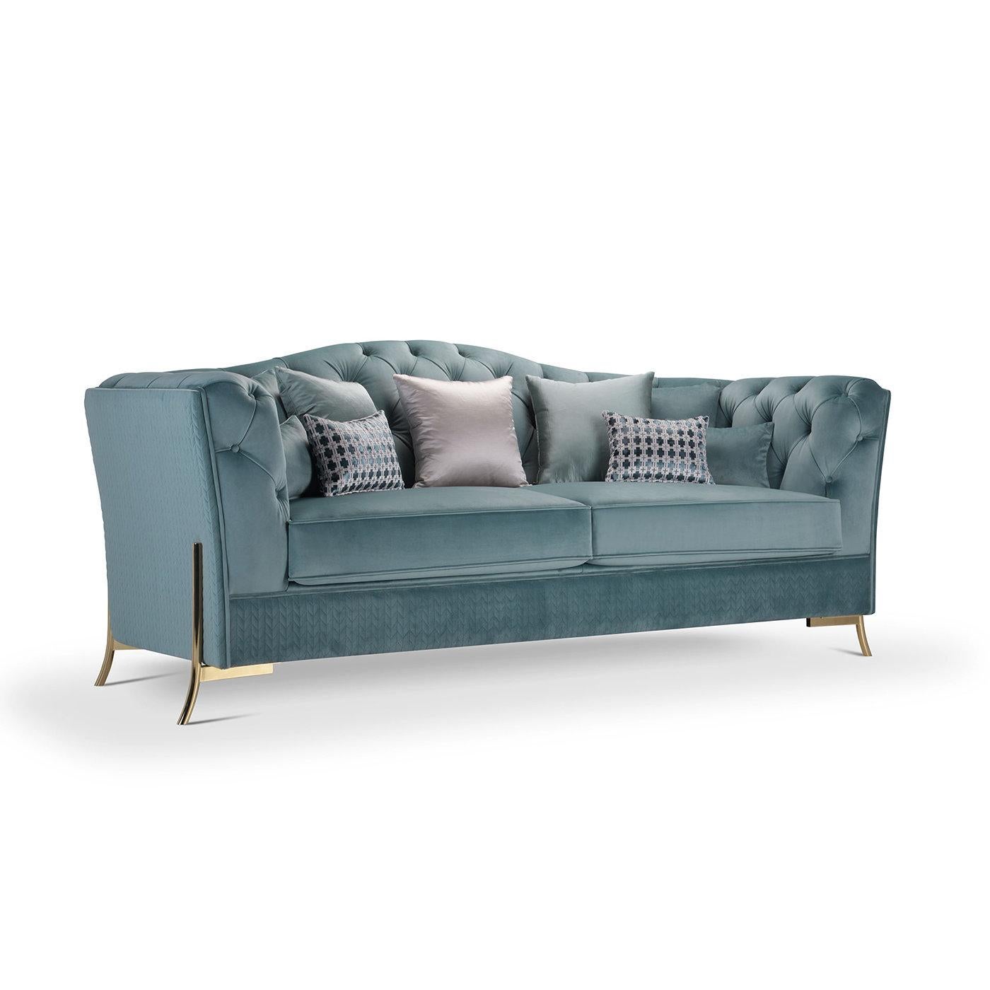 The distinctive features of this lavish sofa are the three plush seats and the striking peacock blue velvet upholstery boasting a capitonne quilted motif all over the wavy backrest. Handcrafted with great care, this imposing yet graceful design