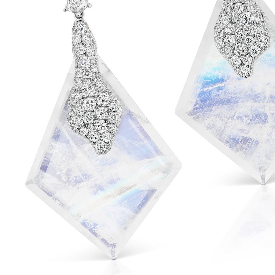 Yulong Drop Earrings by Neha Dani feature a pair of 41.90 Carat Custom cut Blue Moonstones and 1.6 Carat special Shield Cut Diamonds. Inspired by majestic glaciers, the earrings are set with 2.80 Carat Round Diamonds in 18K White Gold.
