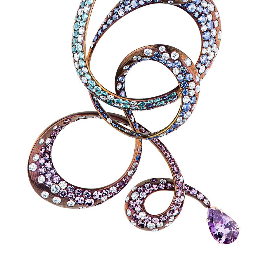 The Irene Necklace by Neha Dani presents a custom-colored Titanium spiral pendant anchored by a 14.30 Carat Pear shape Blue Zircon and a 1.50 Carat Pear shape Purple Sapphire. Irene's swirls are set with 3.22 Carat Blue Sapphires and 2.85 Carat