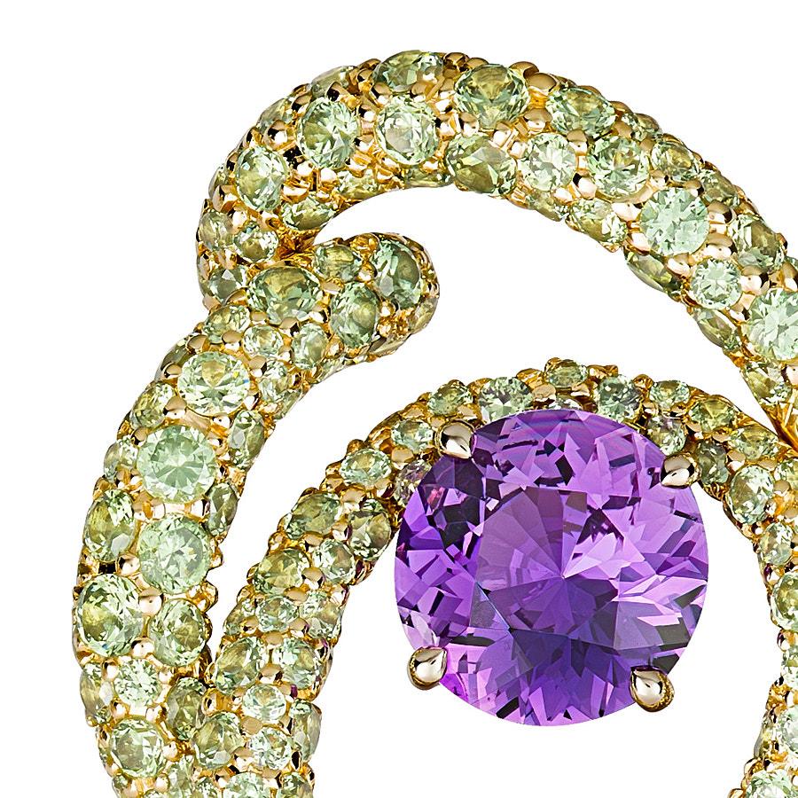 Kalon Clip Earrings by Neha Dani feature 2 Round Purple Sapphires (no heat) of 2.93 Carat. These are surrounded by colourful swirls of 6.39 Carat Green Demantoid Garnets, set in 18K Yellow Gold.
