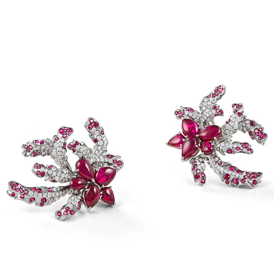 The Roseate Ear Tops by Neha Dani seem to twirl like a bird in
the sky, sparkling with 2.57 Carat Round Brilliant Cut Diamonds and 3.17 Carat Rubies set on
Natural Grey Titanium. Stunning 13.59 Carat Ruby Pear Cabochons hold the brilliant plumage
