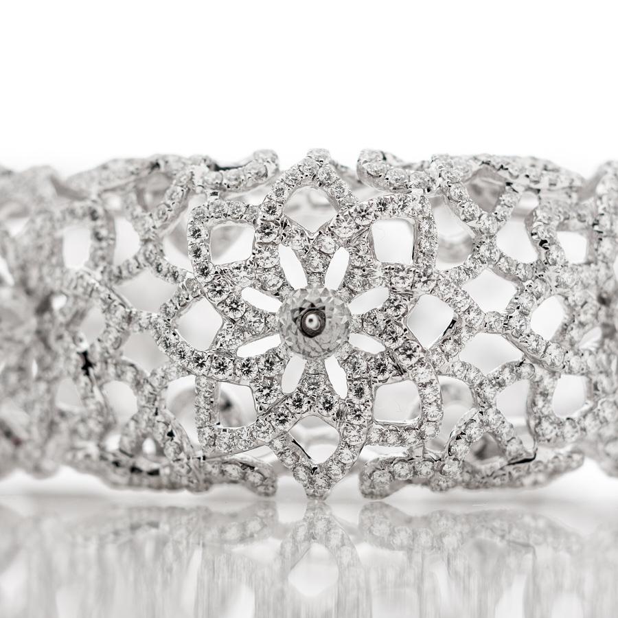 The Leela Bangle Bracelet by Neha Dani is delicately set with 13.85 Carat Full-cut White Diamonds and 5.06 Carat White Diamond Beads. Full of architectural details, this intricate bangle is set in 18K White Gold.