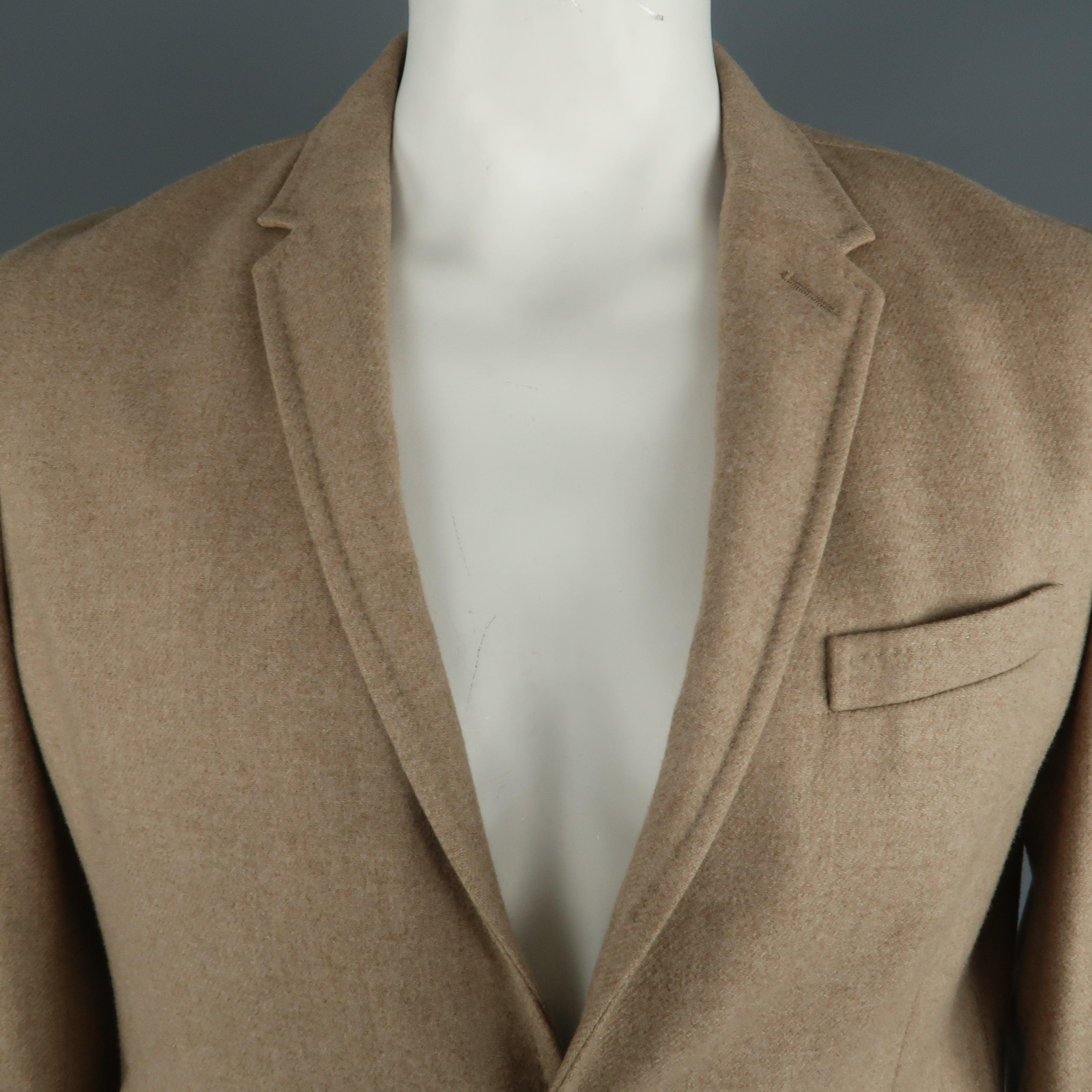 NEIL BARRETT sport coat comes in a camel wool featuring a notch lapel, two button closure, and flap pockets. Made in Italy. 
Excellent Pre-Owned Condition.
 

Marked:   XL
 

Measurements: 
  
l	Shoulder: 19 inches  
l	Chest: 42 inches  
l	Sleeve: